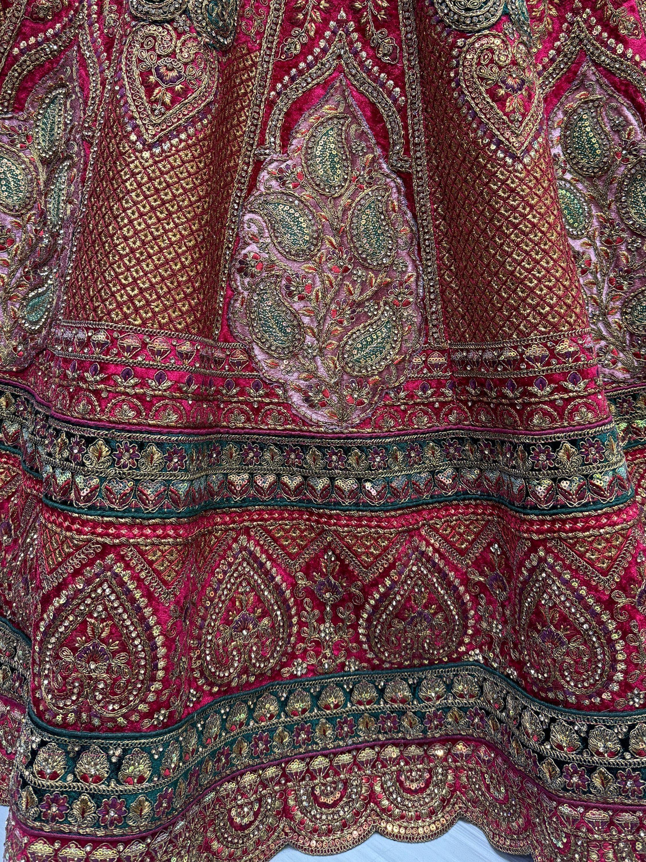 Richly embroidered Indian ethnic lehenga with gold paisley and sequin detailing on deep pink velvet