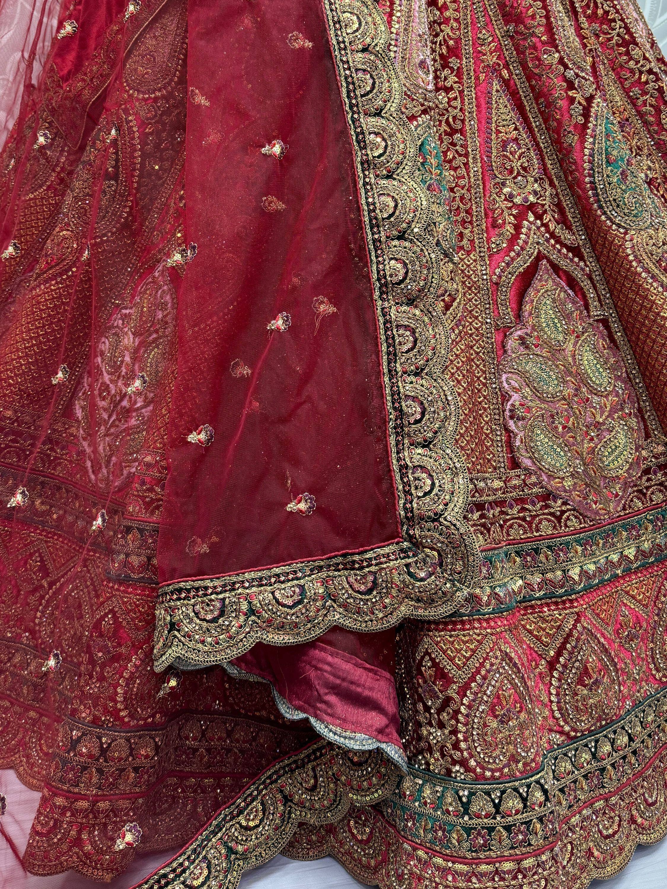Rich maroon lehenga choli with intricate gold embroidery and paisley detailing, perfect for Indian ethnic wear.