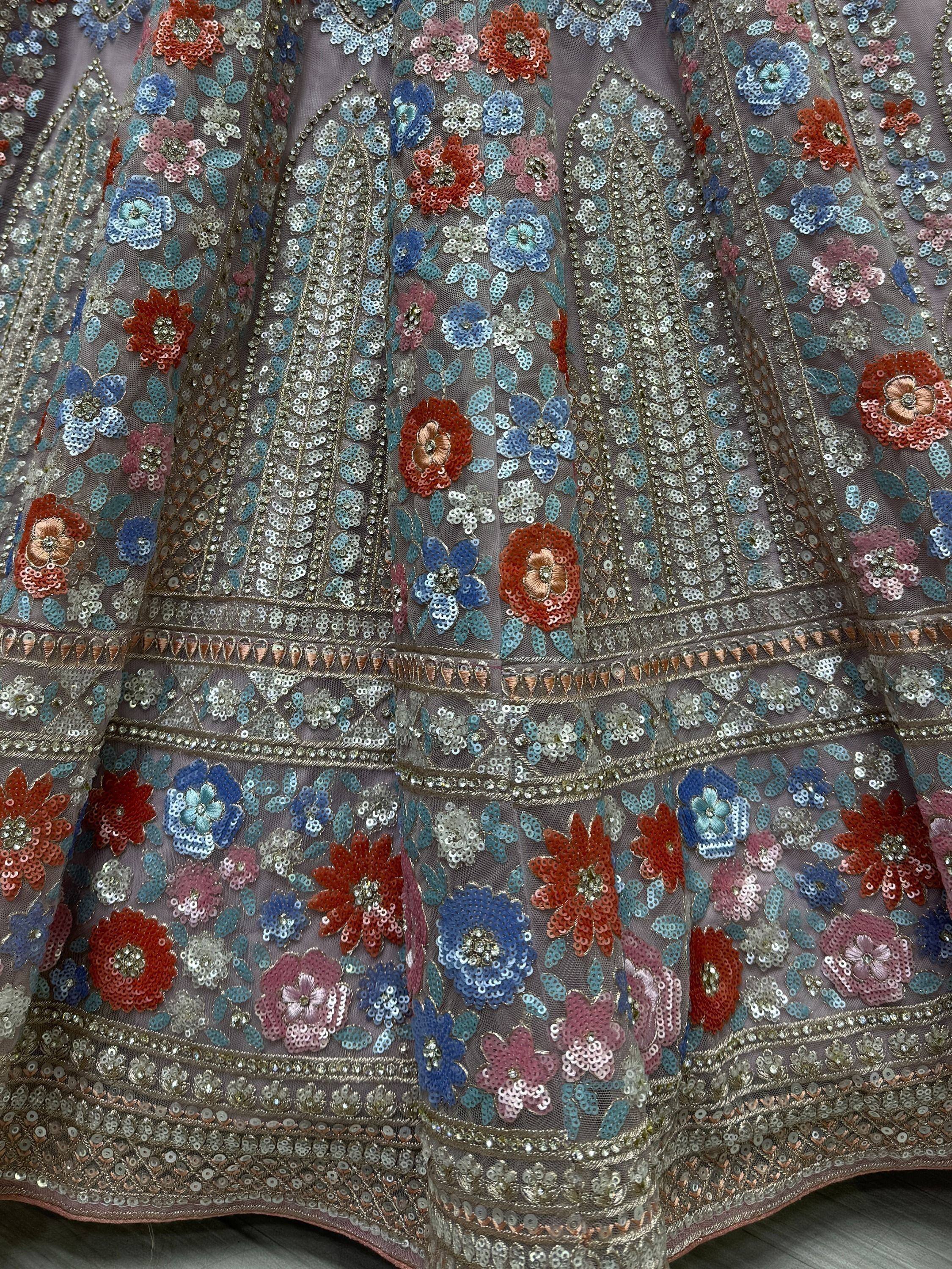 Sequined floral lehenga choli with vibrant blue, pink, and red embroidery for Indian ethnic wear