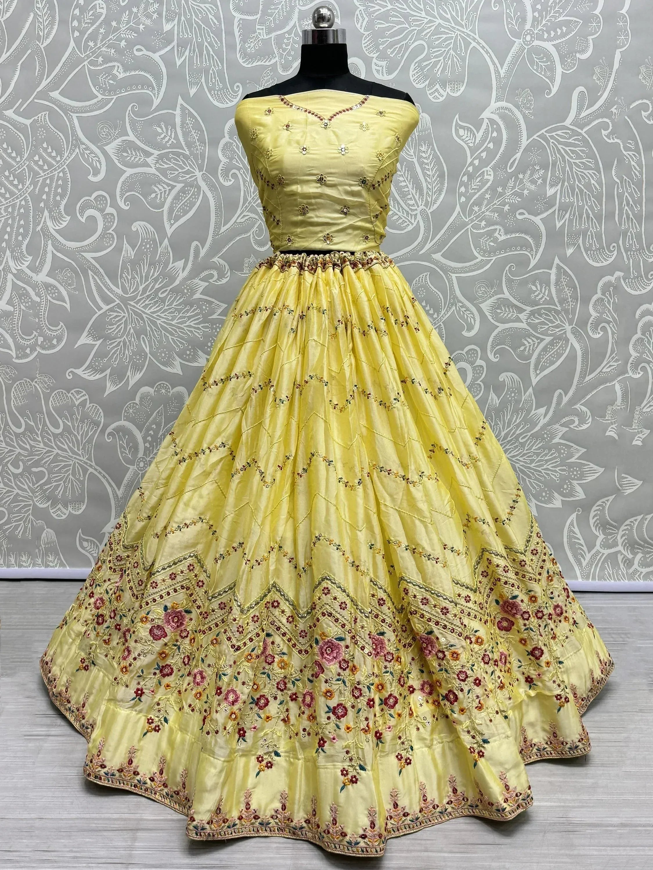 Yellow designer lehenga choli with floral embroidery, perfect for ethnic occasions.