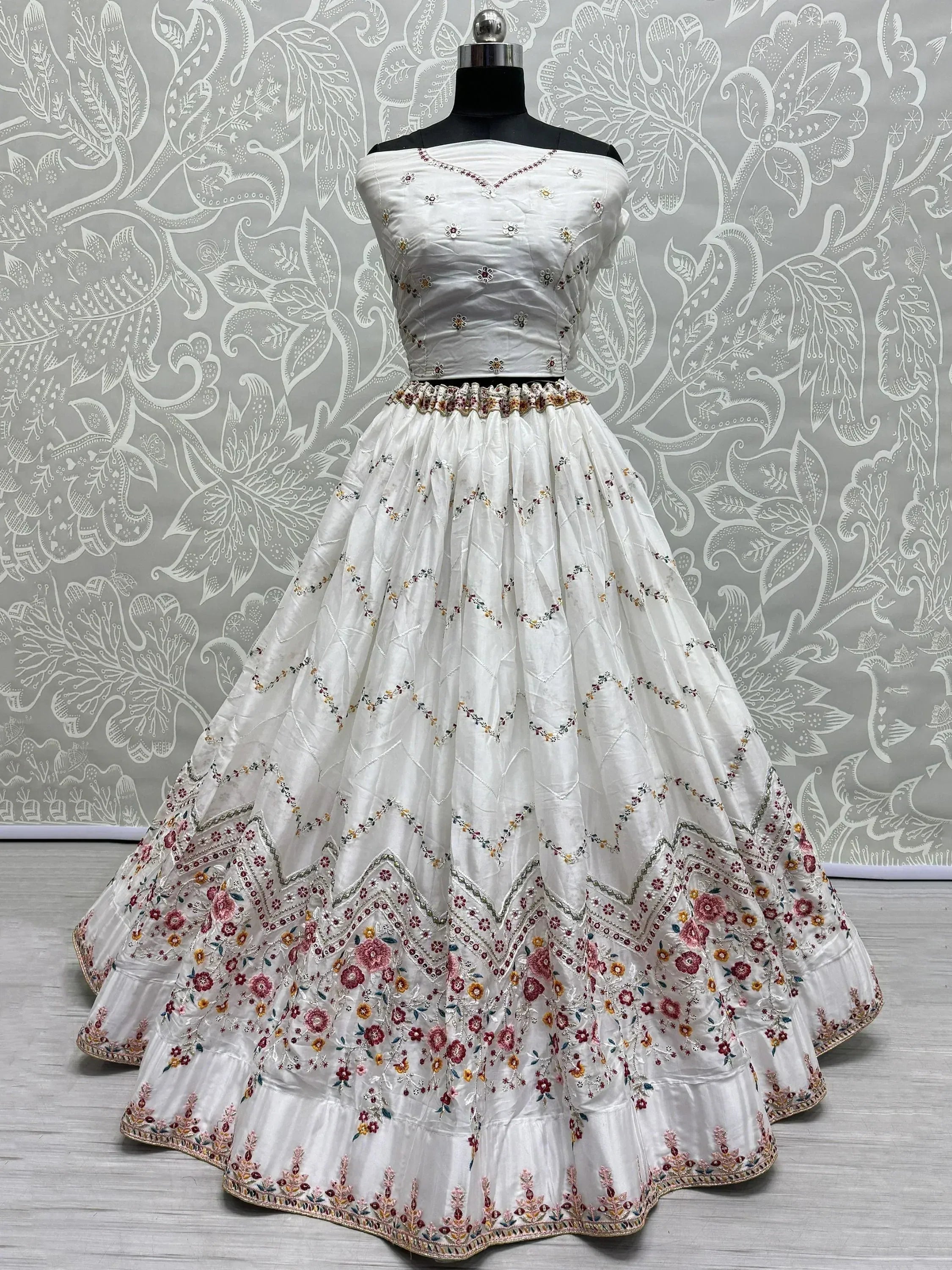 White embroidered lehenga choli with floral motifs, perfect for Indian ethnic wear occasions