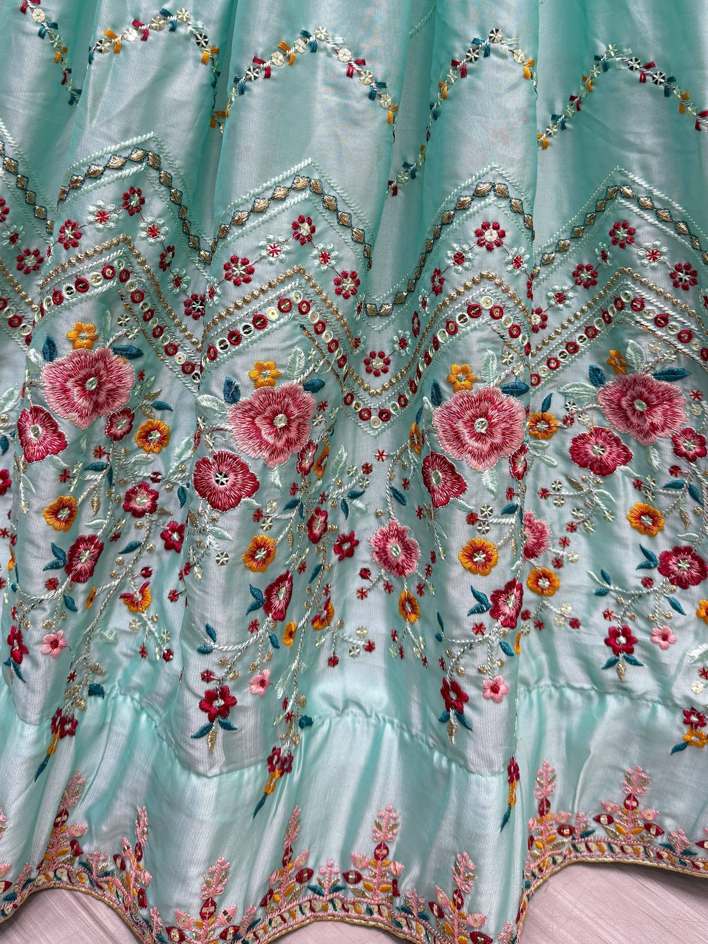 Mint green ethnic lehenga with vibrant floral embroidery and mirror work details
