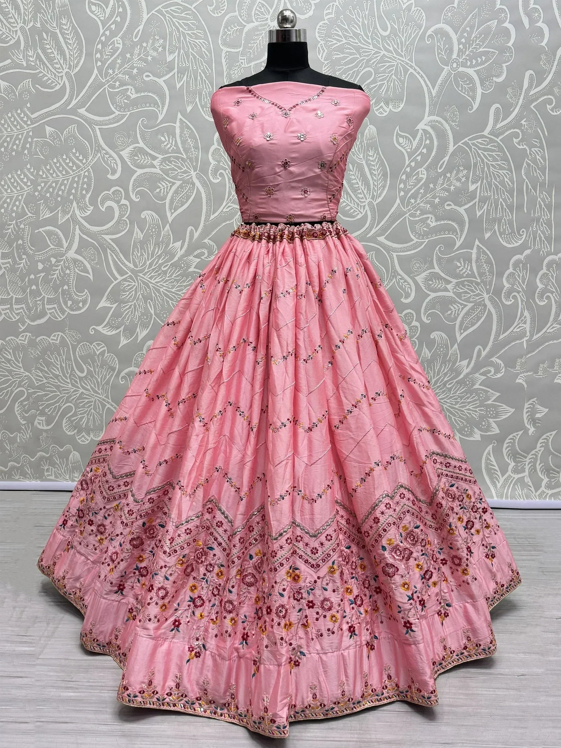 Pink embroidered lehenga choli with floral motifs, off-shoulder blouse, perfect for Indian ethnic occasions