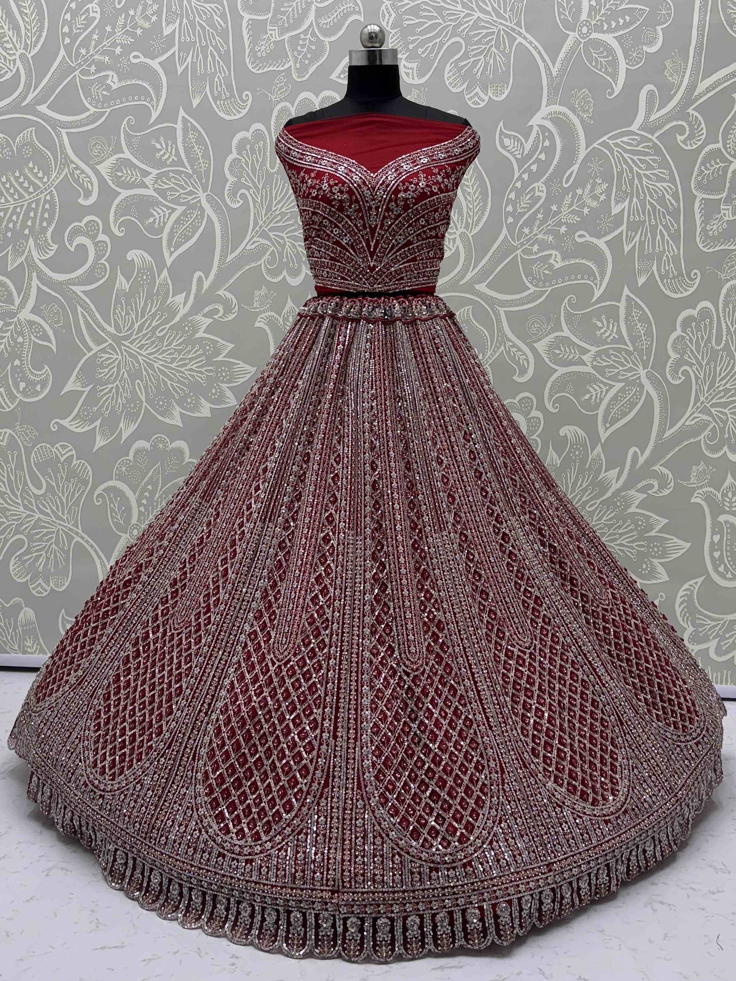 Burgundy designer lehenga choli with heavy silver embroidery and sequins, perfect for weddings and festive occasions.