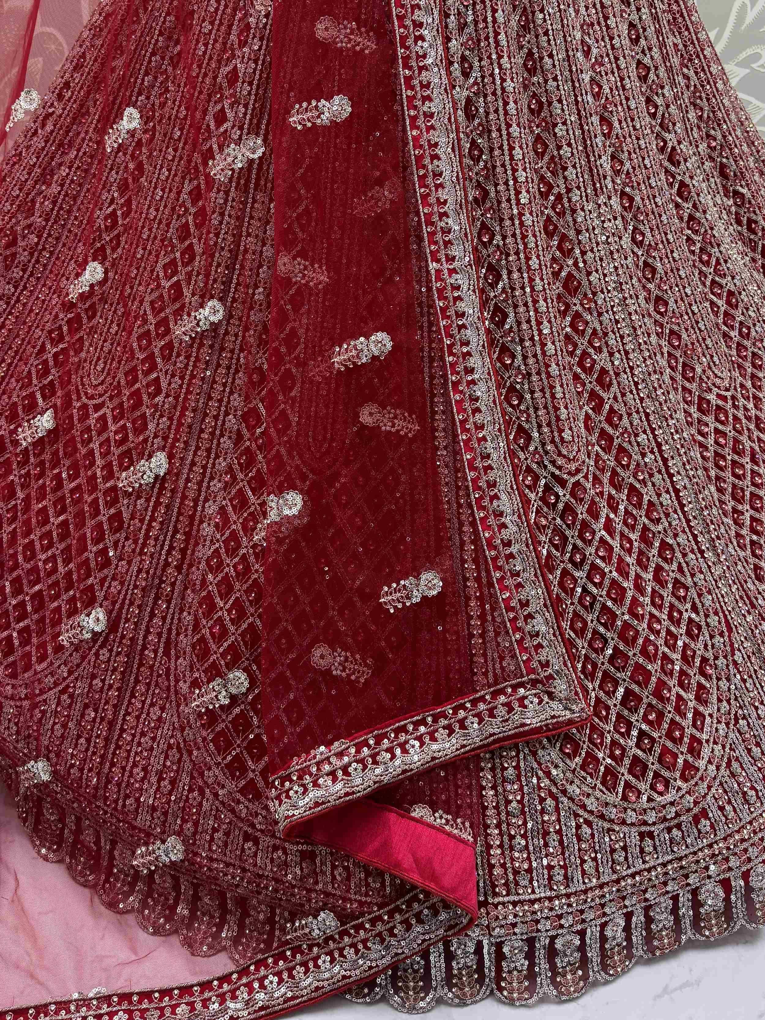 Luxury maroon lehenga choli with intricate silver embroidery and velvet detailing for Indian weddings