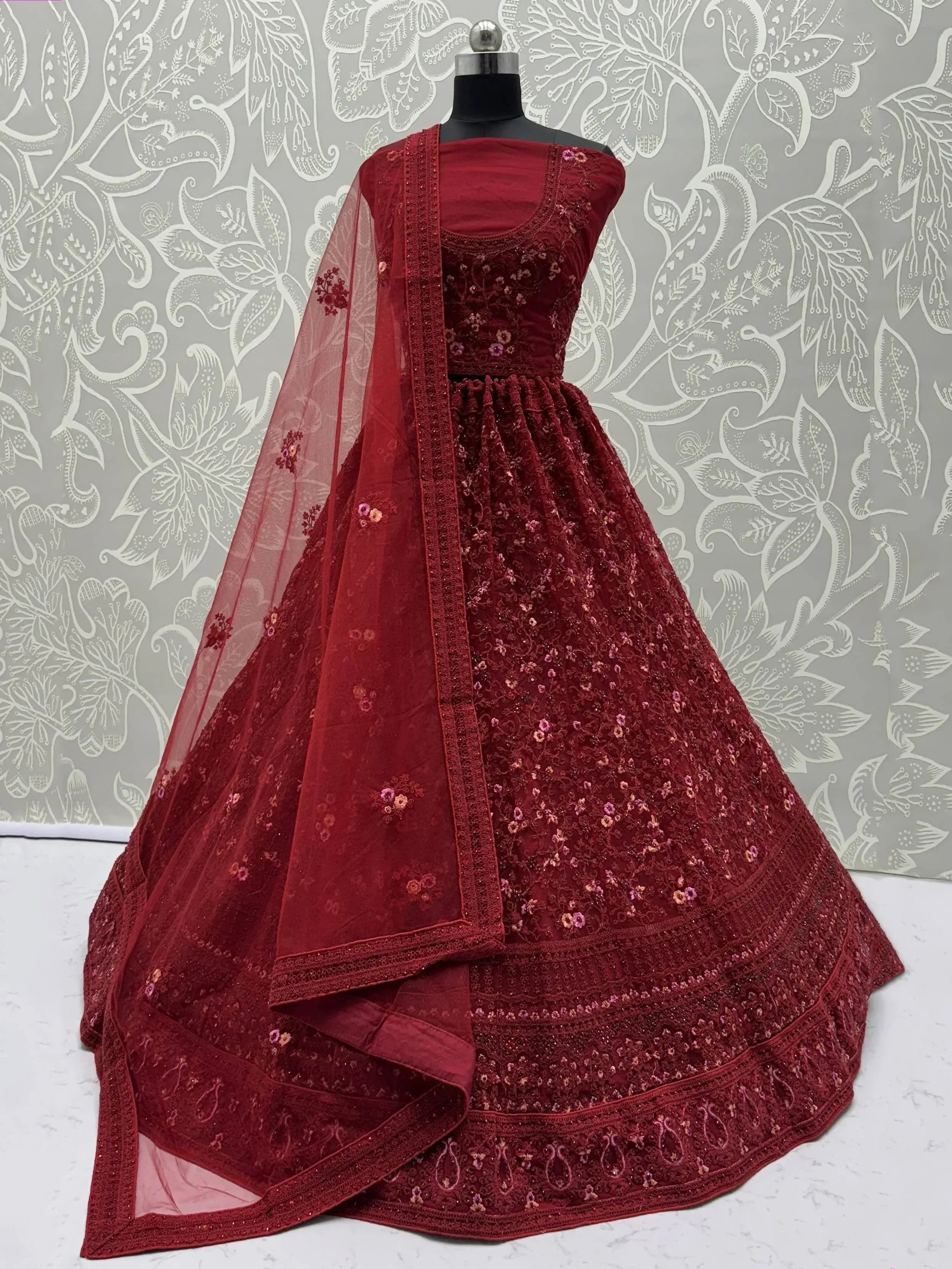 Maroon embroidered lehenga choli with floral detailing and sheer dupatta, ideal for Indian ethnic wear occasions