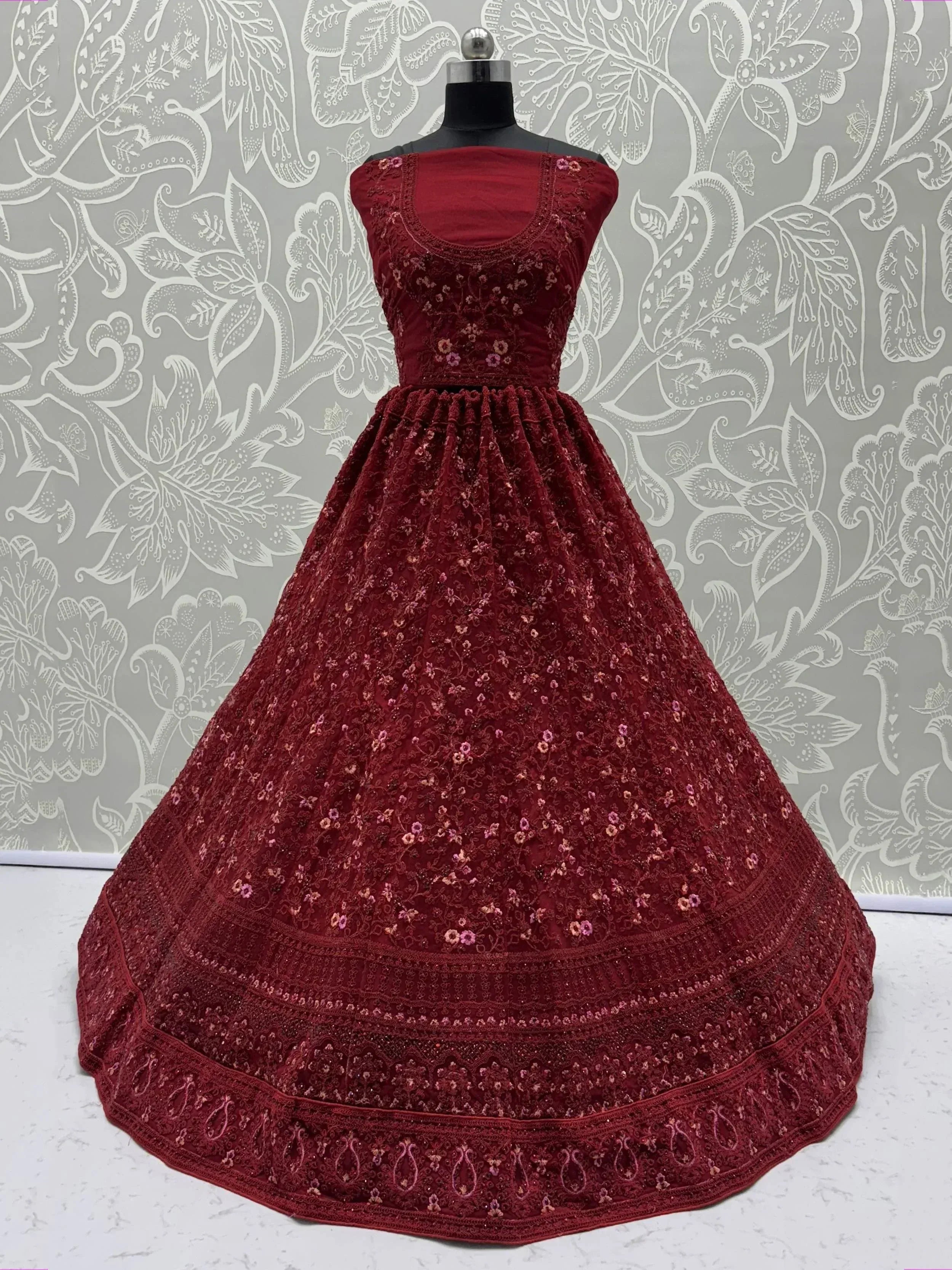 Maroon embroidered ethnic gown with floral detailing, perfect for Indian festive occasions