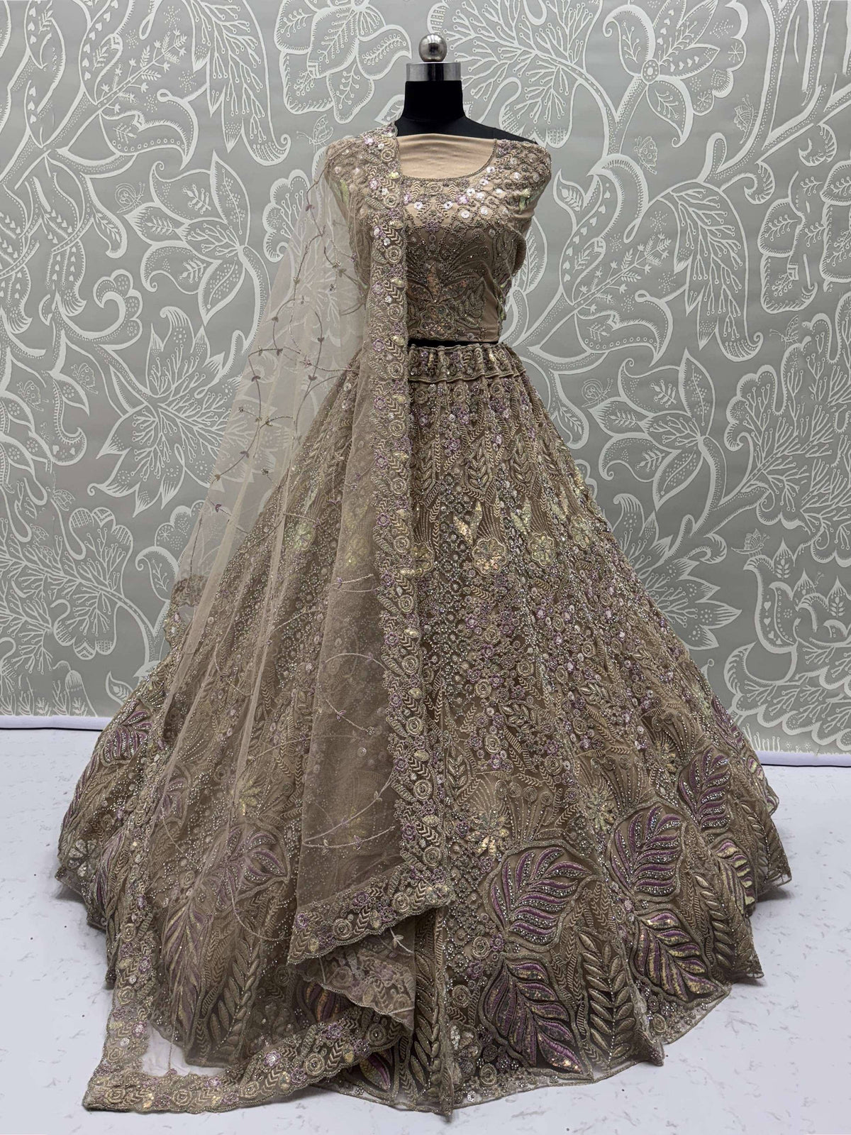 Elegant gold and purple embroidered lehenga choli with net dupatta, perfect for Indian weddings and festive occasions.