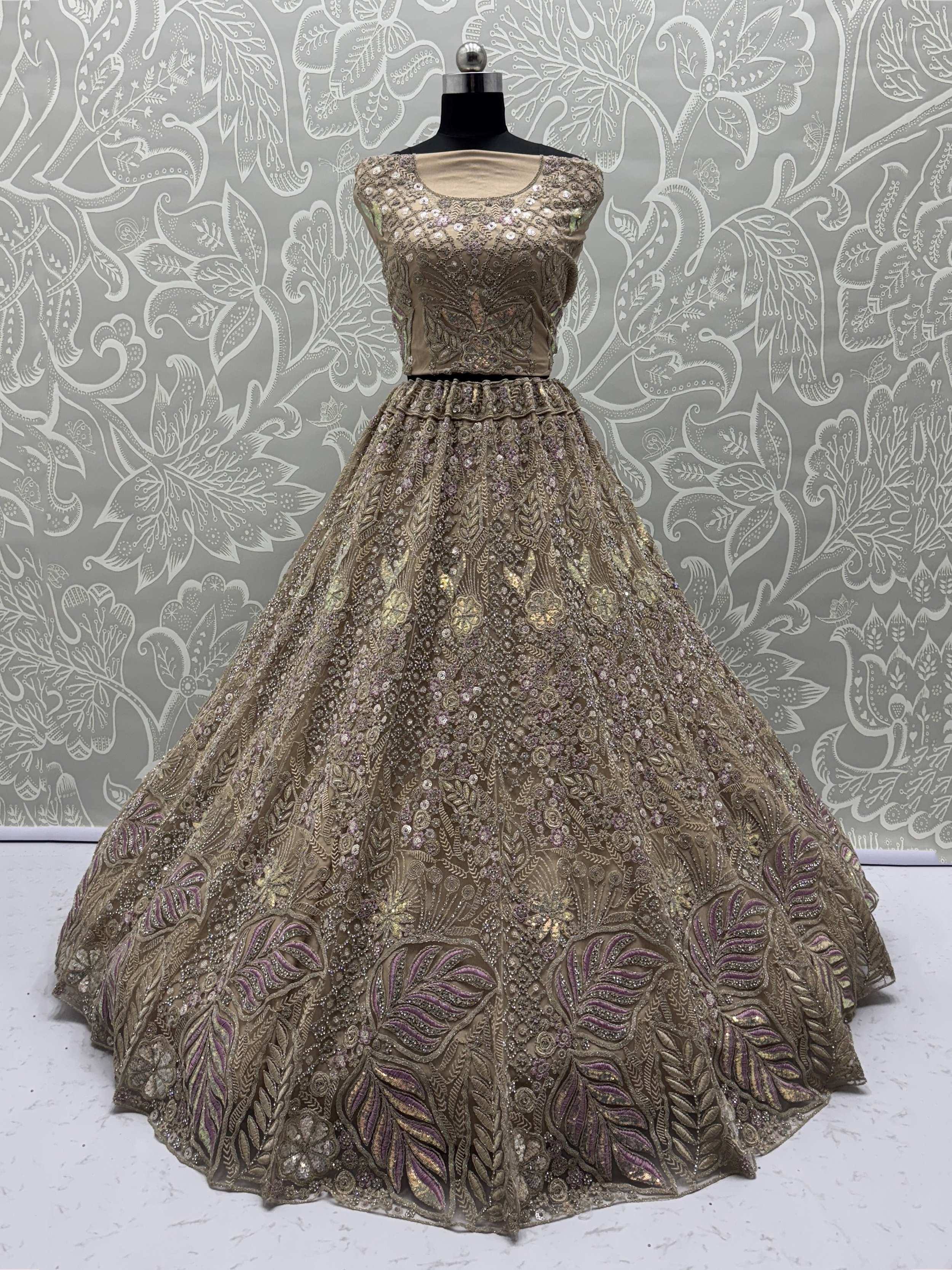 Elegant gold ethnic gown with intricate embroidery and sequin work, perfect for Indian weddings and celebrations.