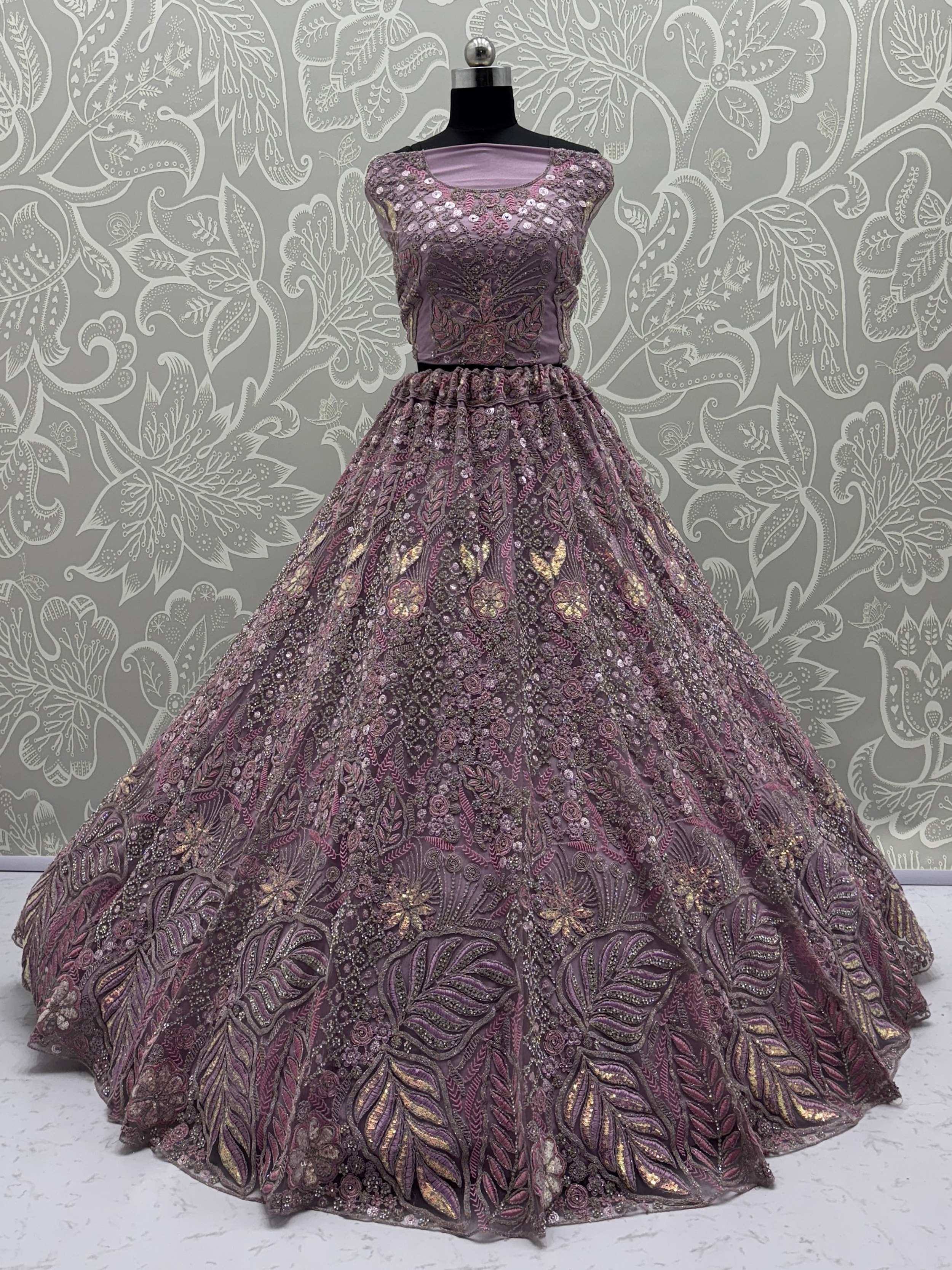 Elegant purple designer lehenga choli with heavy floral embroidery and sequins, perfect for Indian weddings.