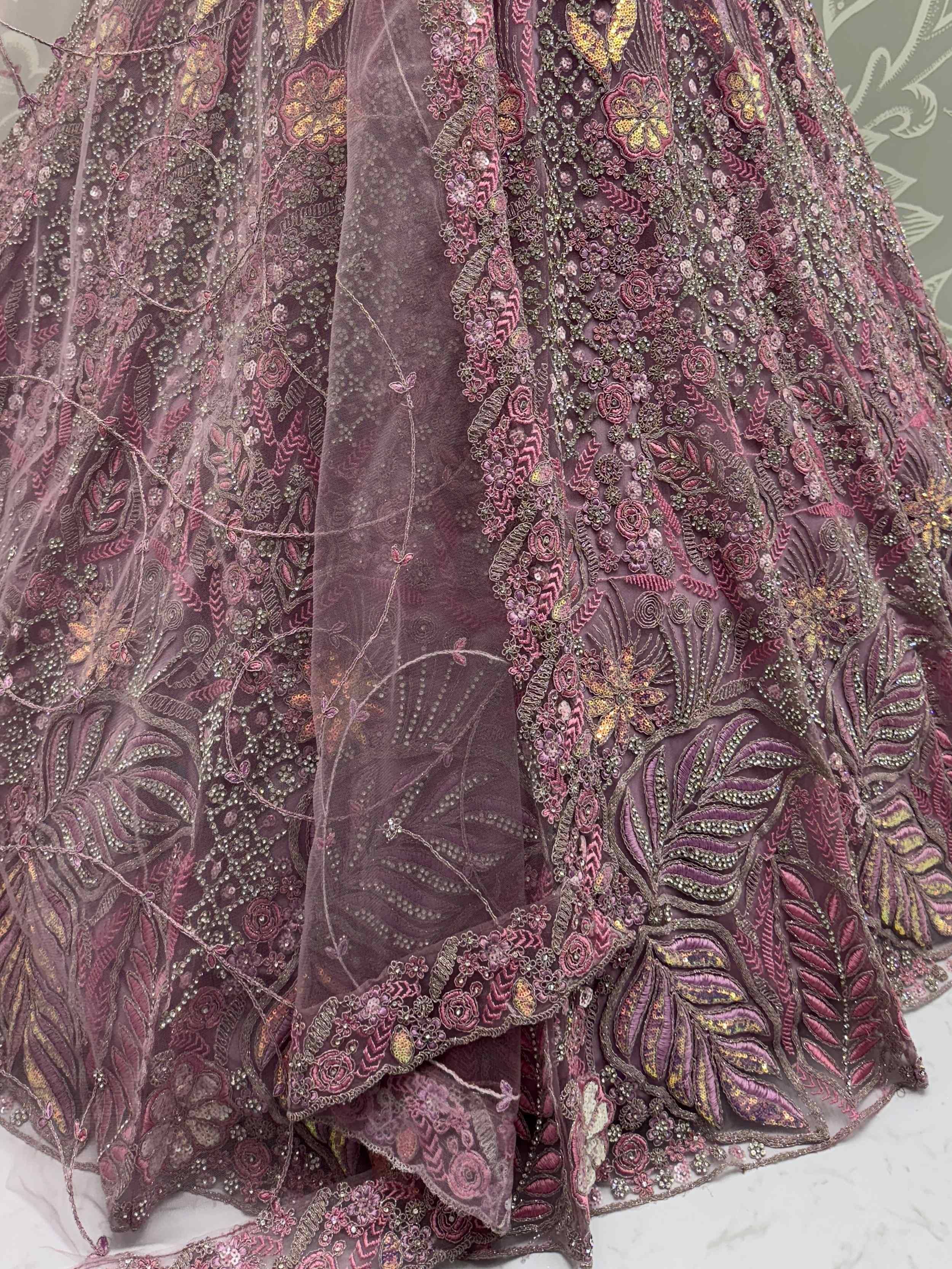 Elegant purple lehenga with intricate floral embroidery and sequin detailing, perfect for Indian ethnic wear.