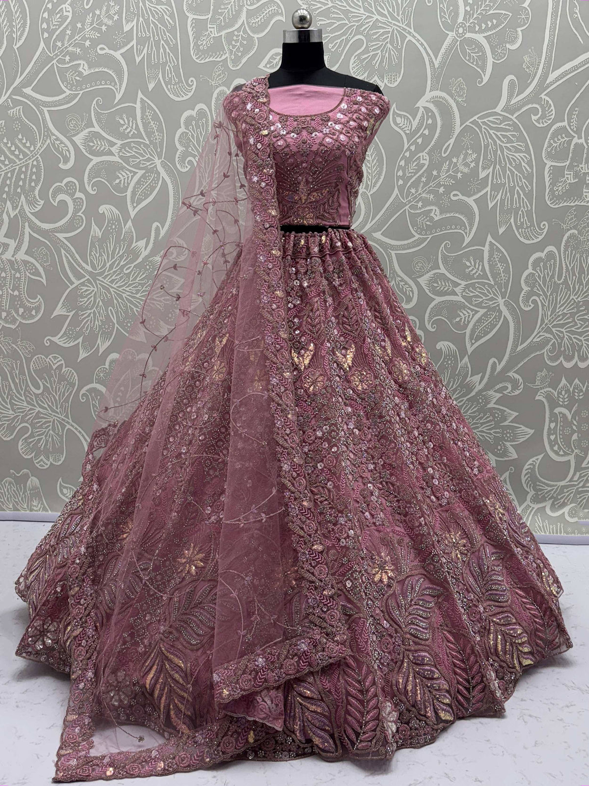 Pink designer lehenga choli with heavy embroidery and net dupatta, perfect for Indian weddings and festive occasions.