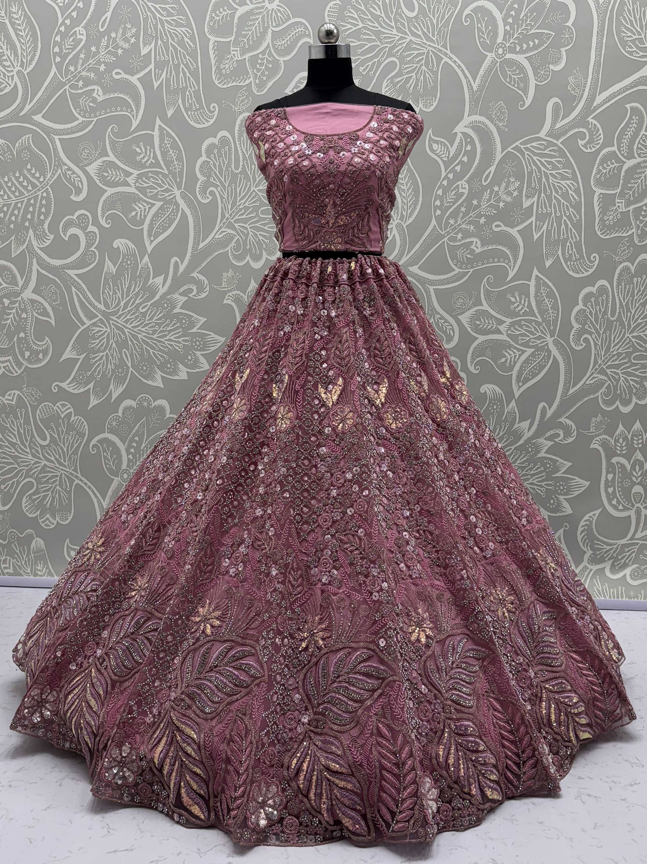Elegant maroon lehenga choli with intricate gold embroidery and sequins, perfect for Indian ethnic wear.