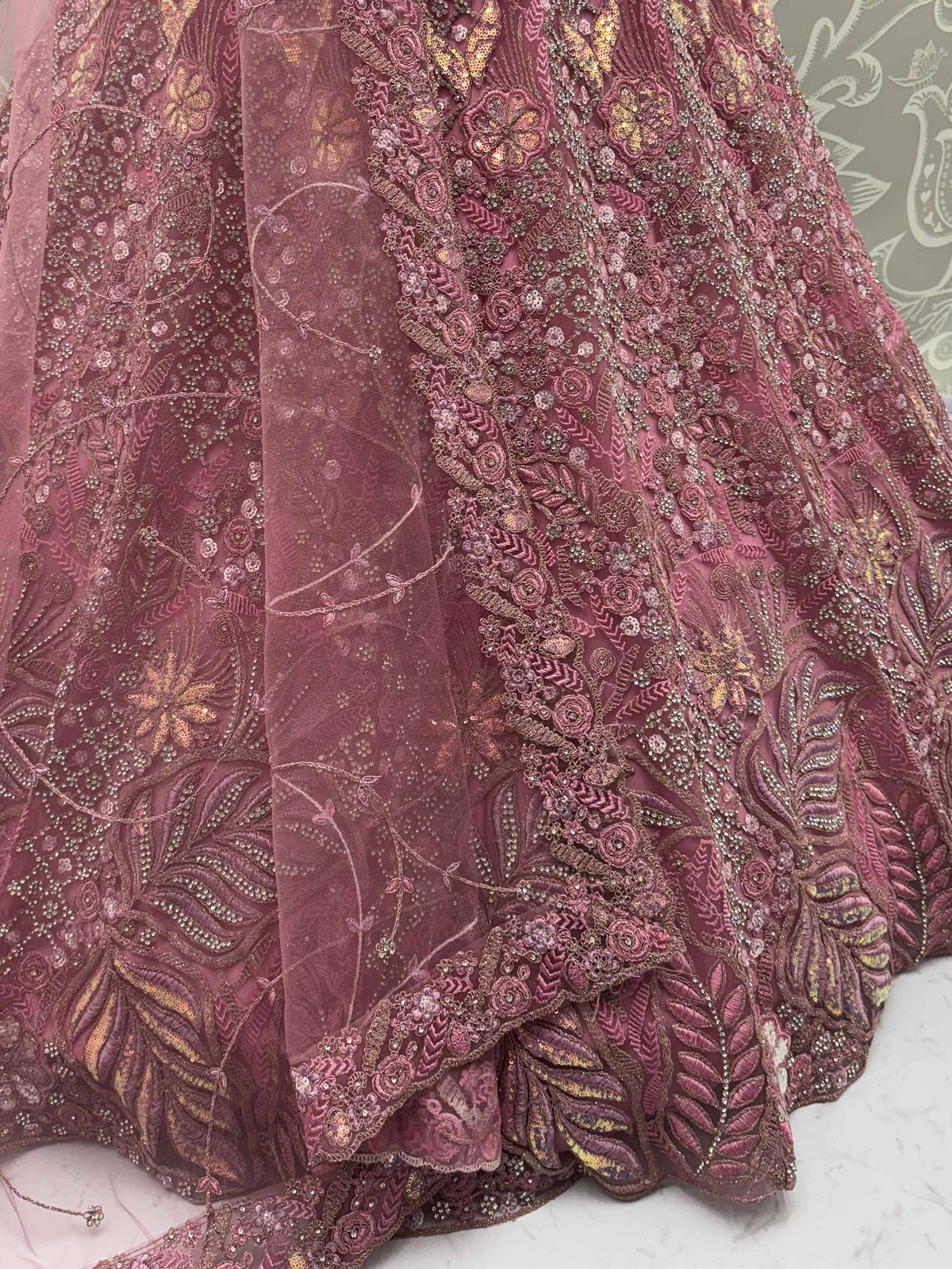 Dusty rose embroidered lehenga with intricate floral zari work and sequin detailing, perfect for Indian weddings.
