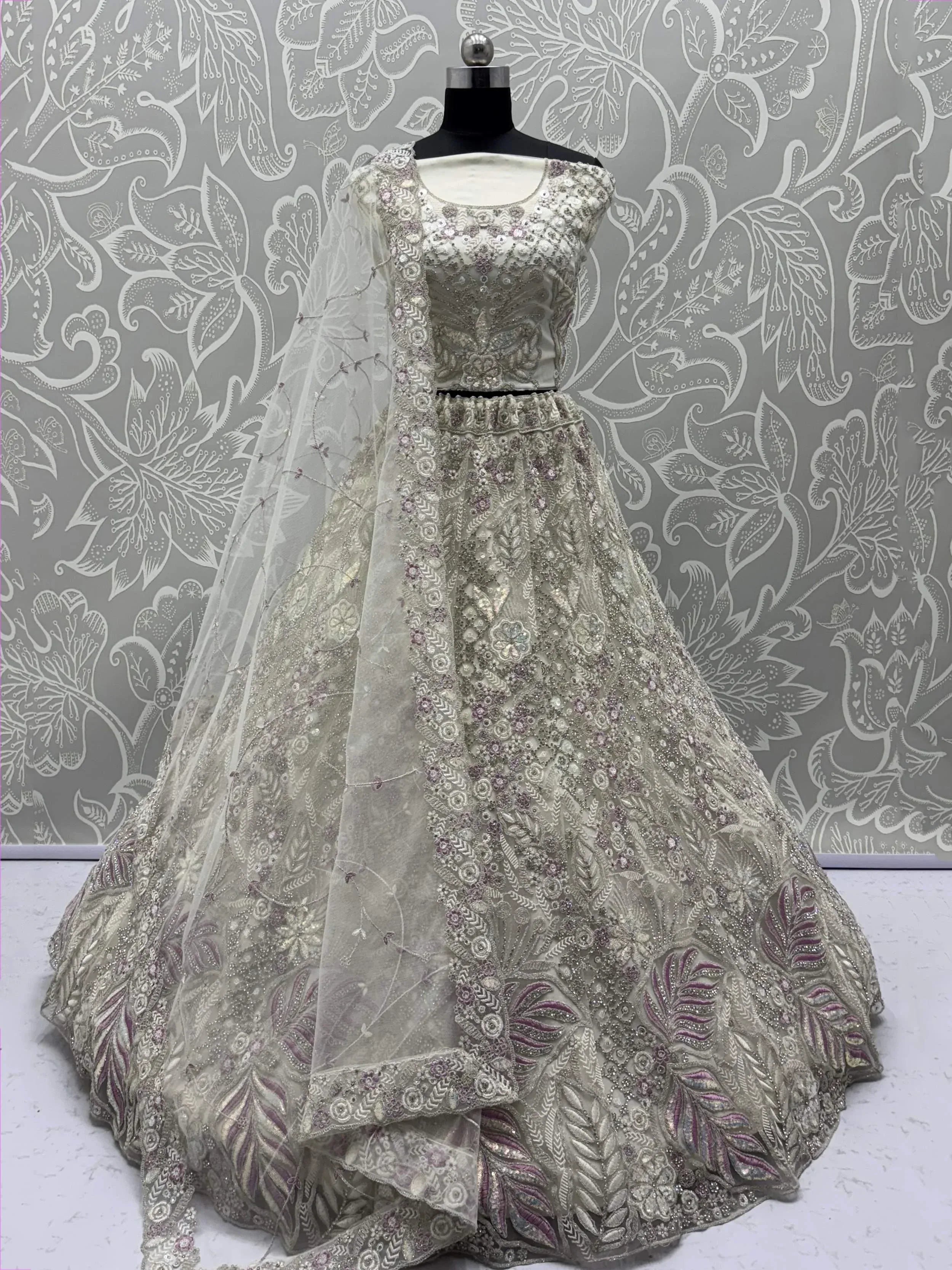 Elegant silver lehenga choli with intricate floral embroidery and sequin work, perfect for weddings and festive occasions.