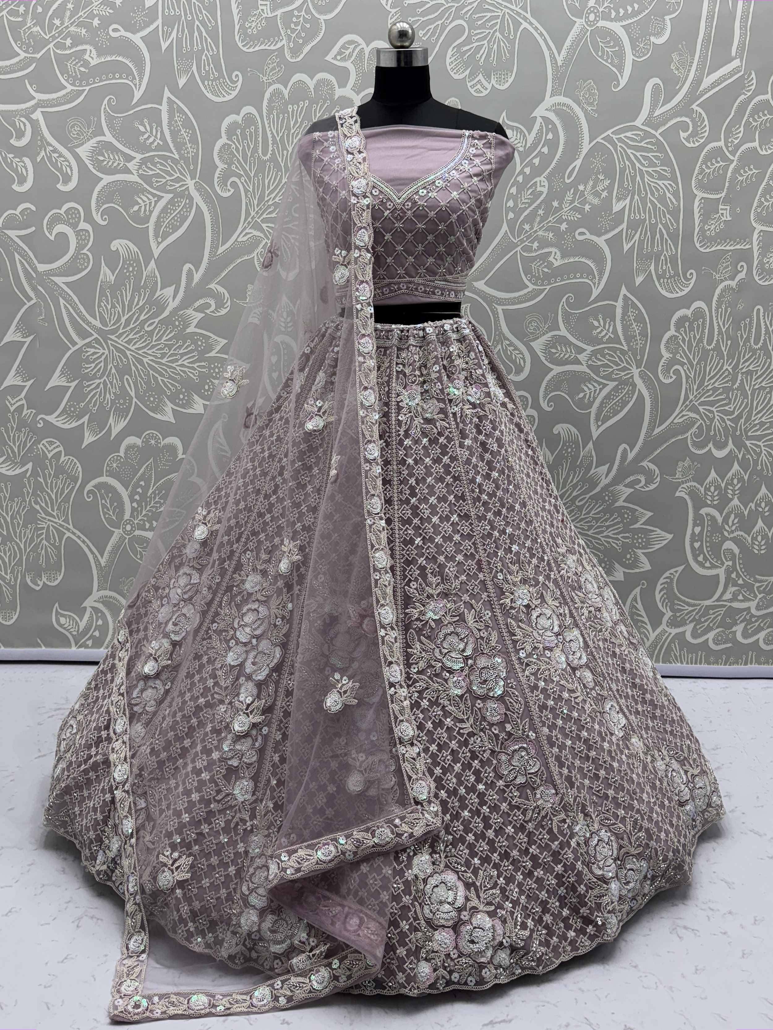 Elegant mauve lehenga choli with intricate floral embroidery and sequin work, perfect for Indian weddings and festive occasions.