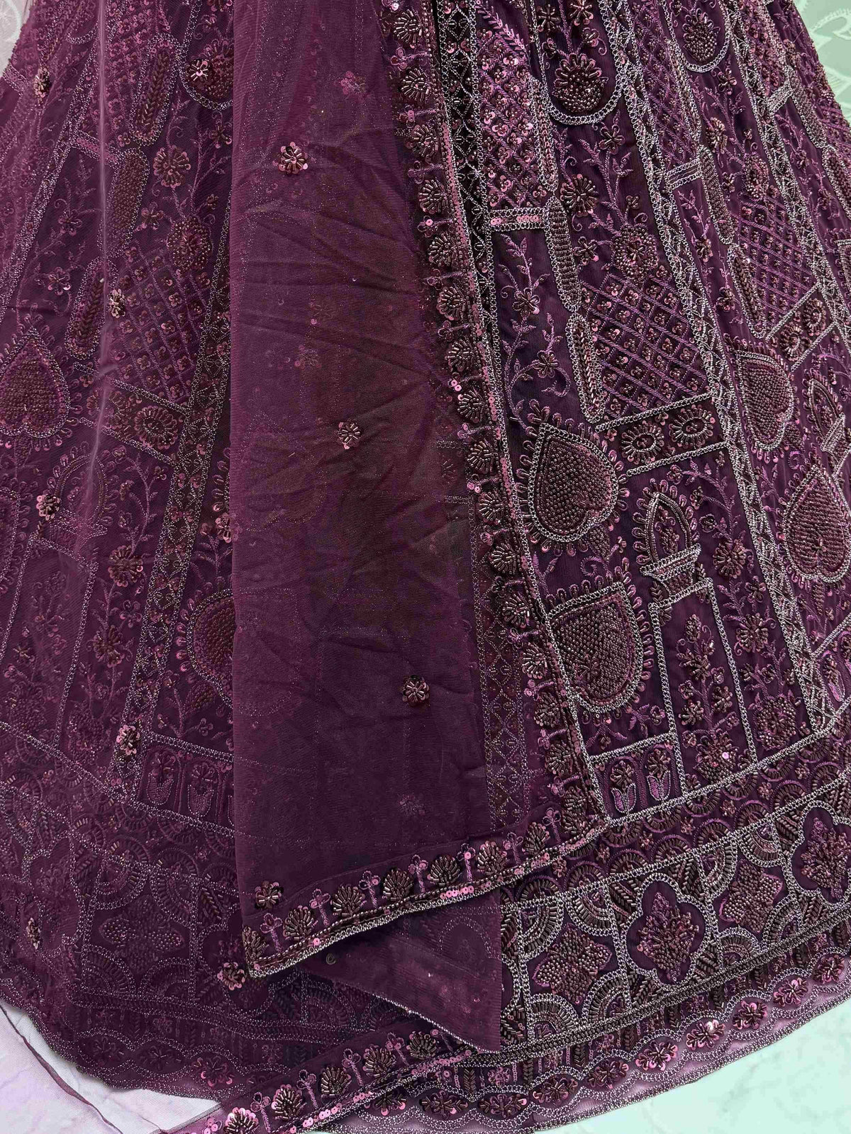 Purple embroidered lehenga choli with intricate beadwork and sequin detailing, perfect for Indian ethnic wear.