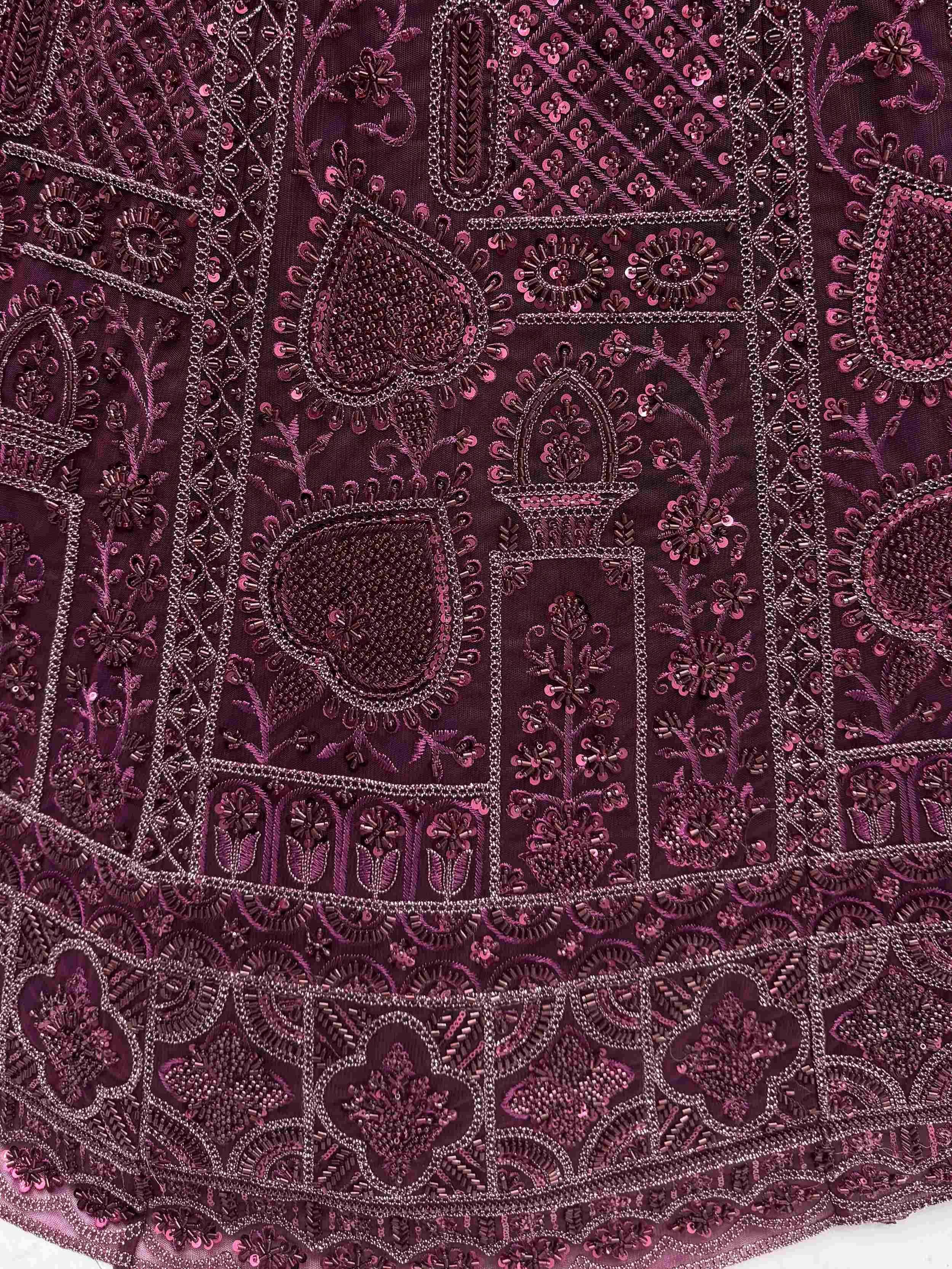 Richly embroidered purple lehenga choli with intricate beadwork and floral patterns