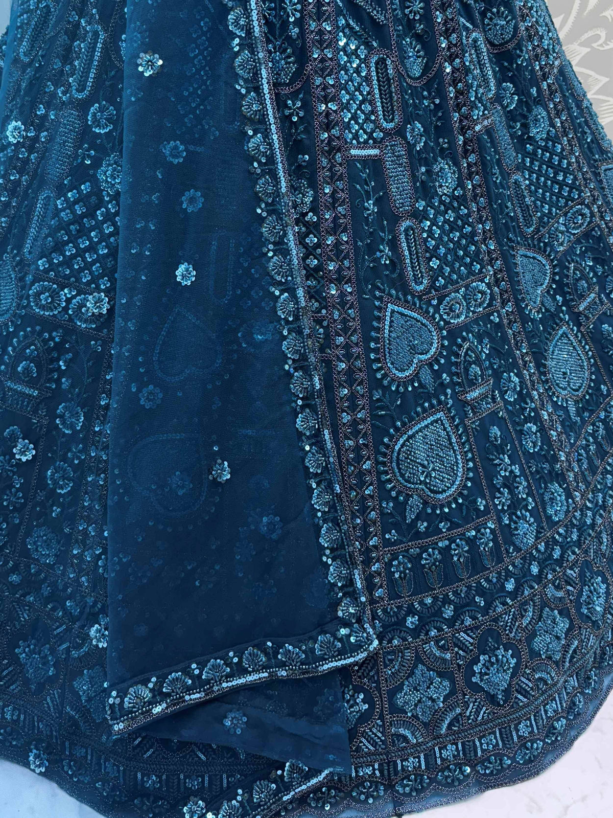 Dark blue ethnic gown with intricate sequin and bead embroidery, perfect for Indian weddings or festive occasions.