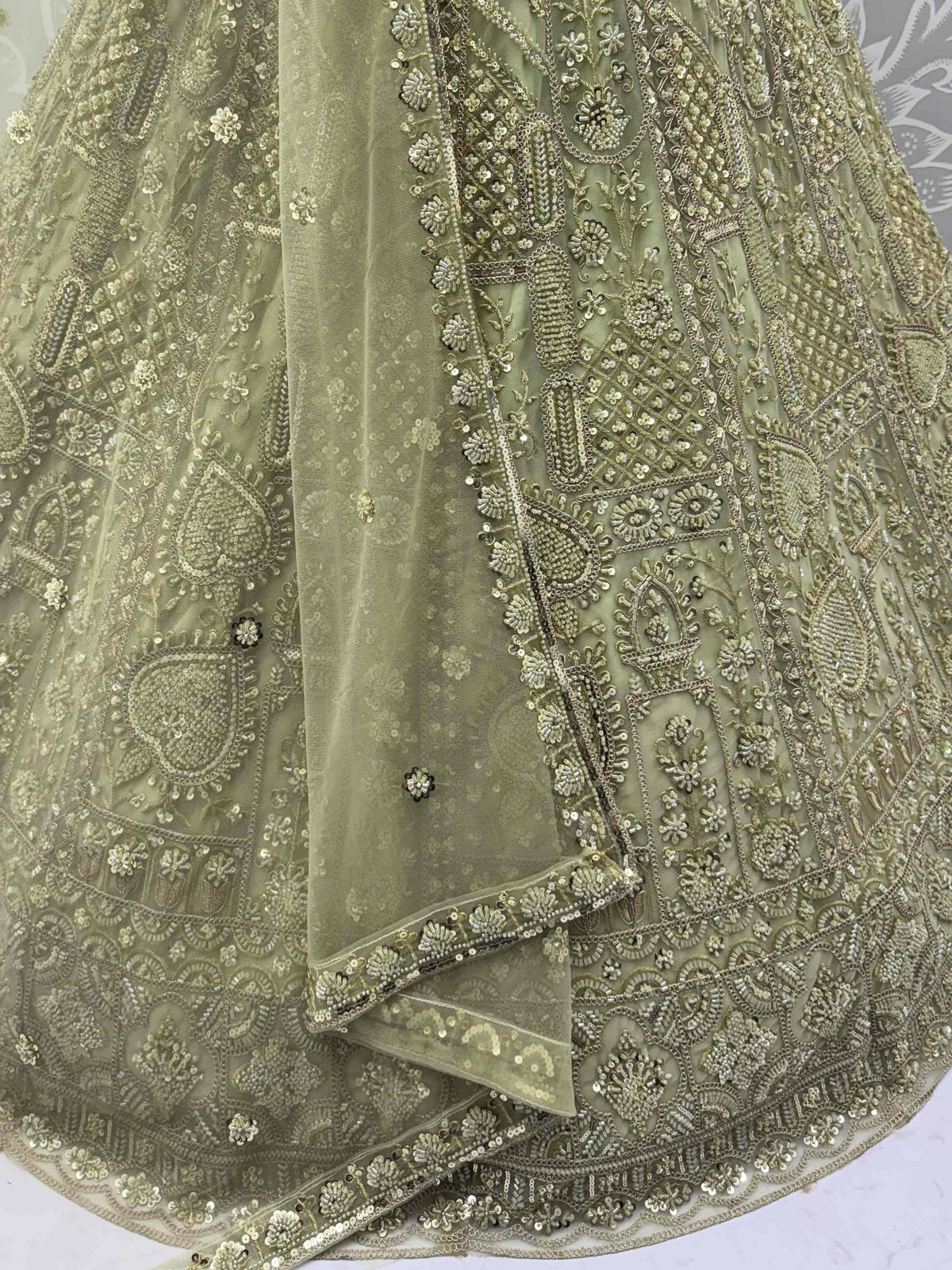 Olive green designer lehenga with intricate gold embroidery and sequin work, perfect for weddings and festive occasions.