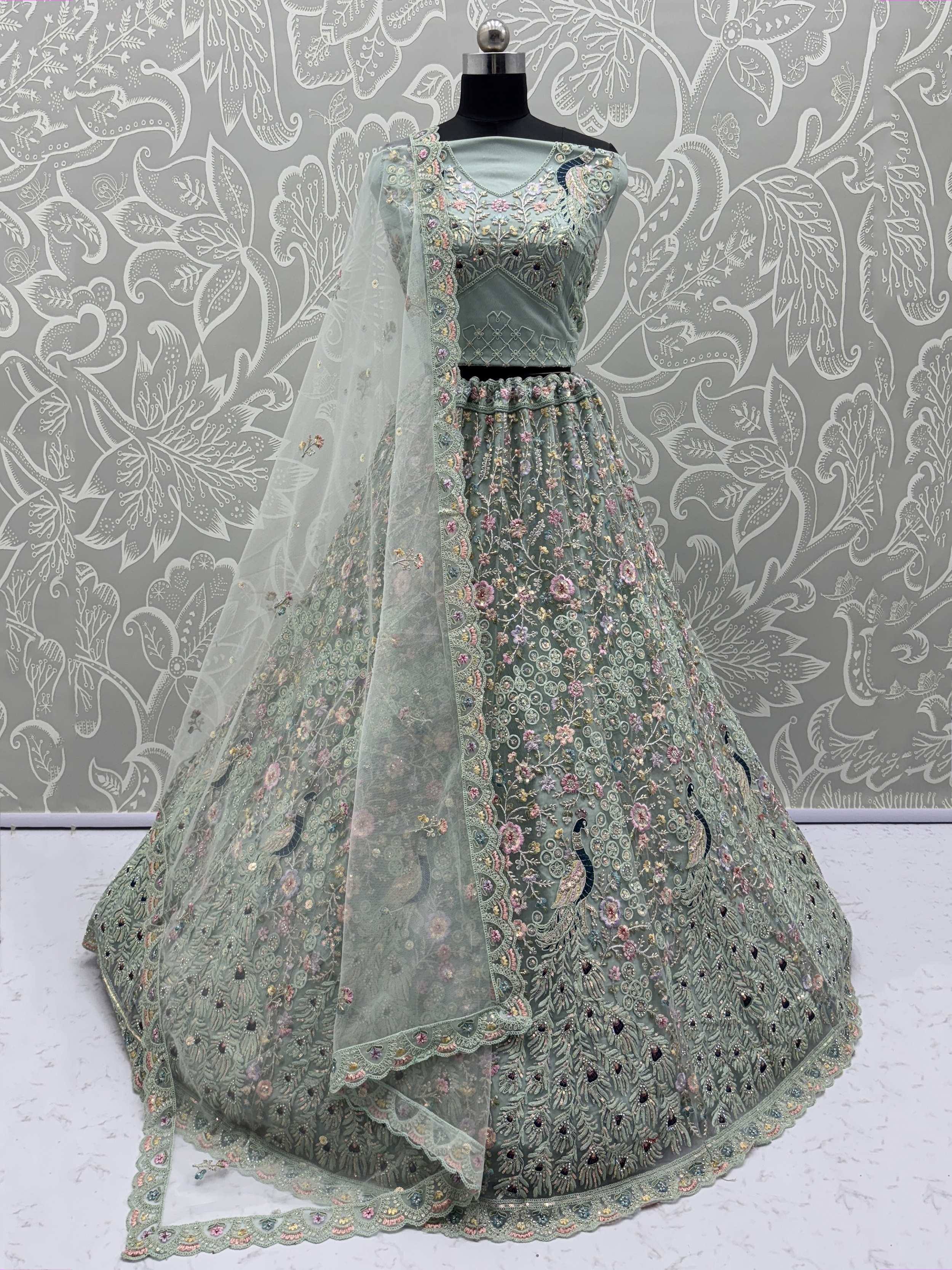 Mint green embroidered lehenga choli with floral and peacock motifs, perfect for Indian ethnic wear occasions.