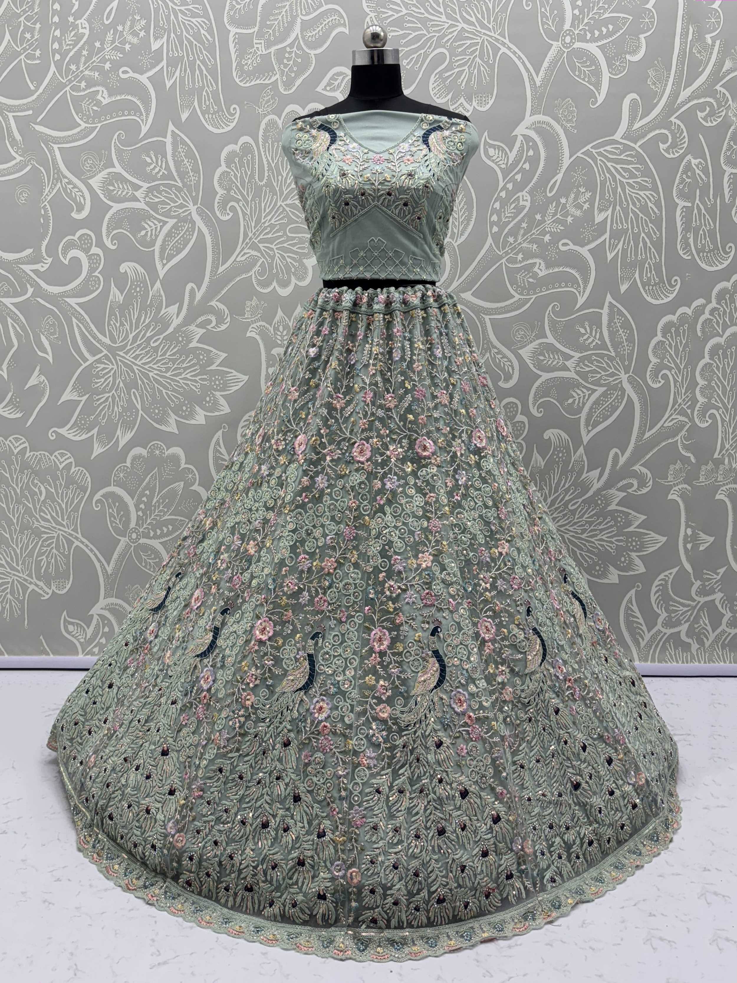 Mint green embroidered lehenga choli with peacock motifs, floral work, and net skirt for Indian ethnic wear