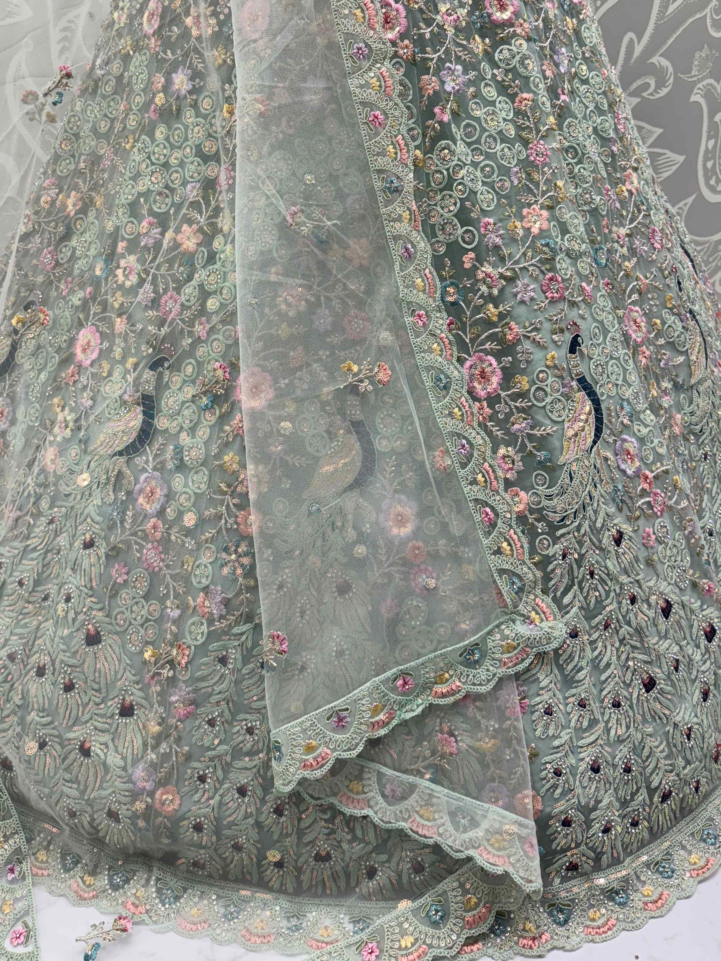 Dazzling Sky Blue Net Zari Embroidered Reception Wear Lehenga Choli