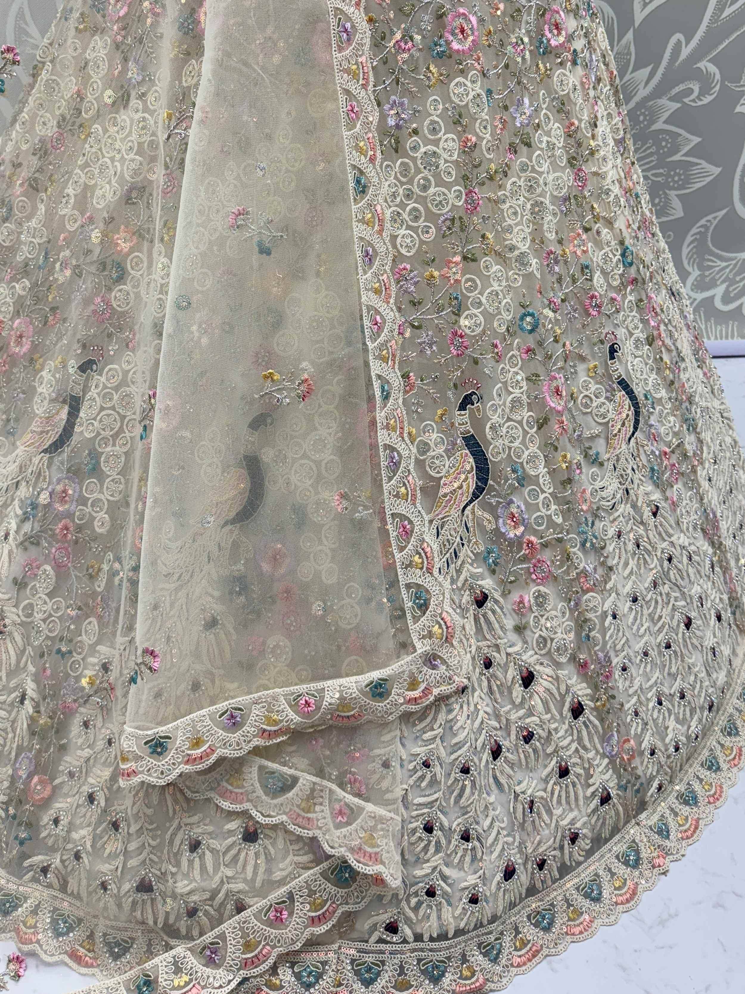 Designer lehenga with peacock embroidery, floral motifs, and lace detailing for Indian ethnic wear