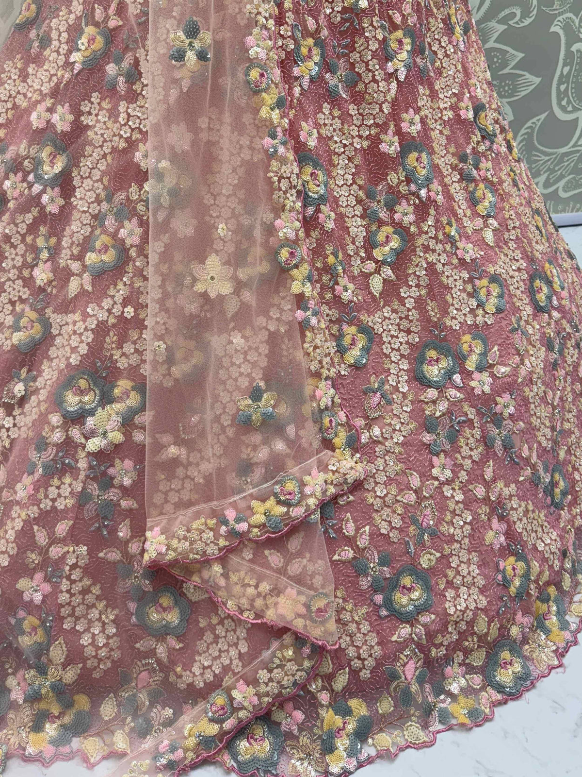 Pink floral embroidered lehenga with sequin detailing and sheer overlay, perfect for Indian ethnic wear occasions.
