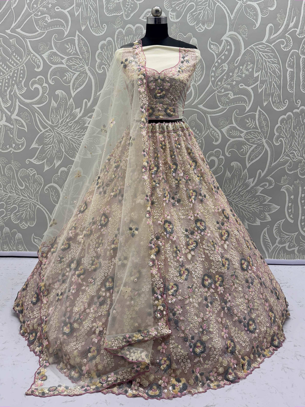 Elegant floral-embroidered lehenga choli with sheer dupatta, perfect for Indian ethnic wear occasions.