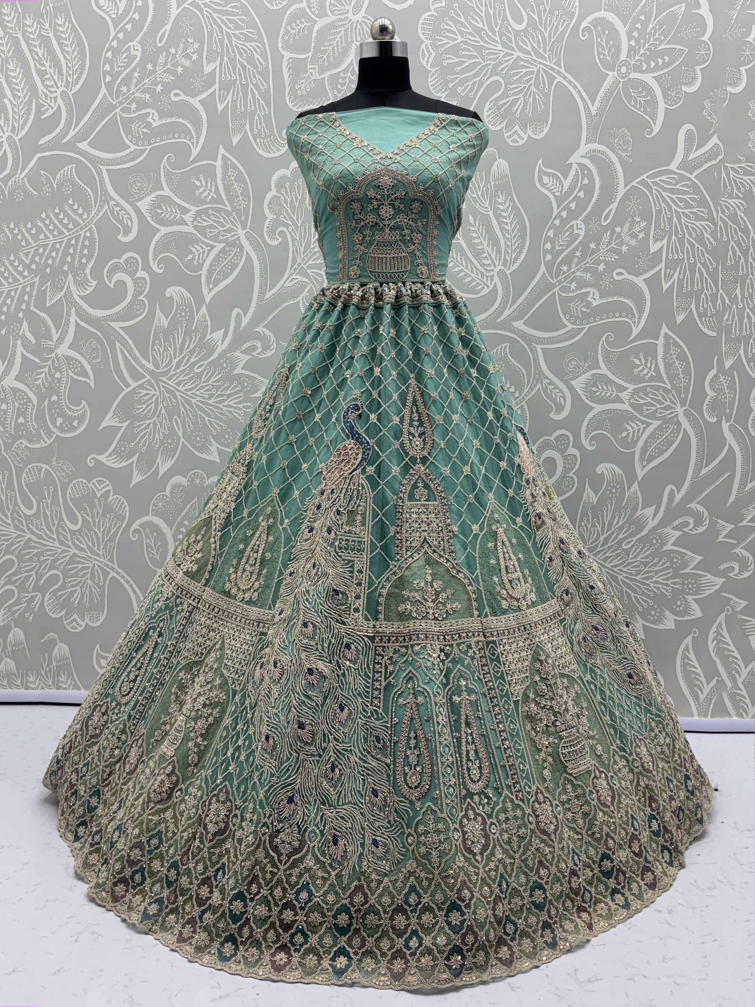 Mint green designer lehenga with peacock embroidery and gold zari work, perfect for Indian weddings and festive occasions.