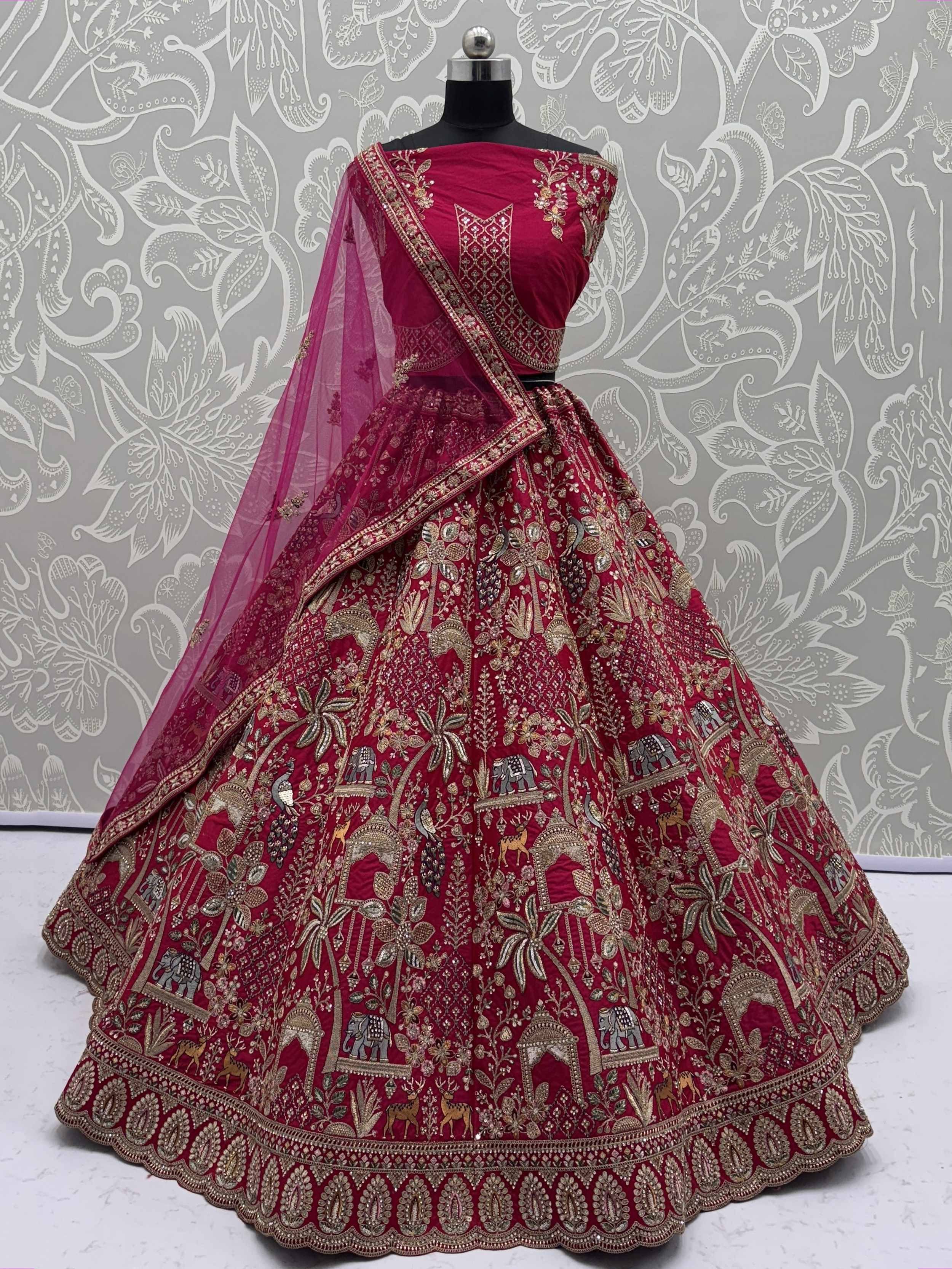 Rich maroon lehenga choli with intricate gold embroidery, elephant & peacock motifs, perfect for Indian weddings & festive occasions.