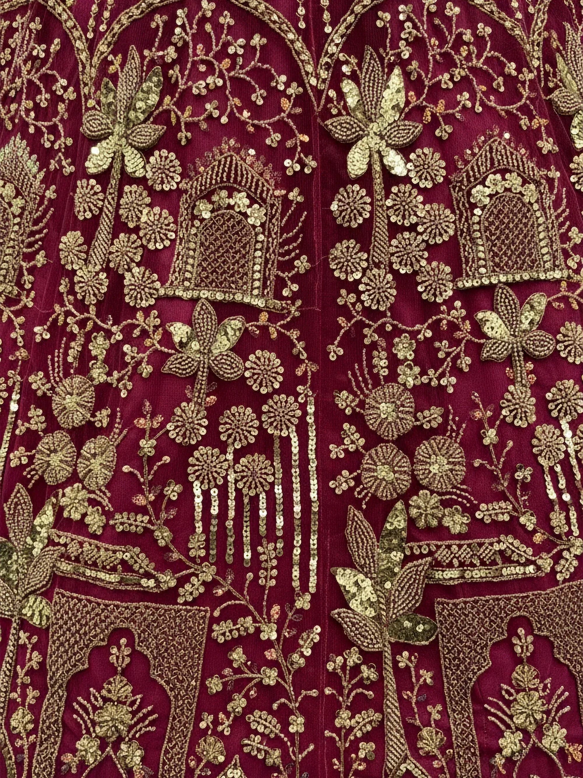 Rich maroon ethnic wear with gold floral and arch embroidery, perfect for Indian designer lehenga or saree
