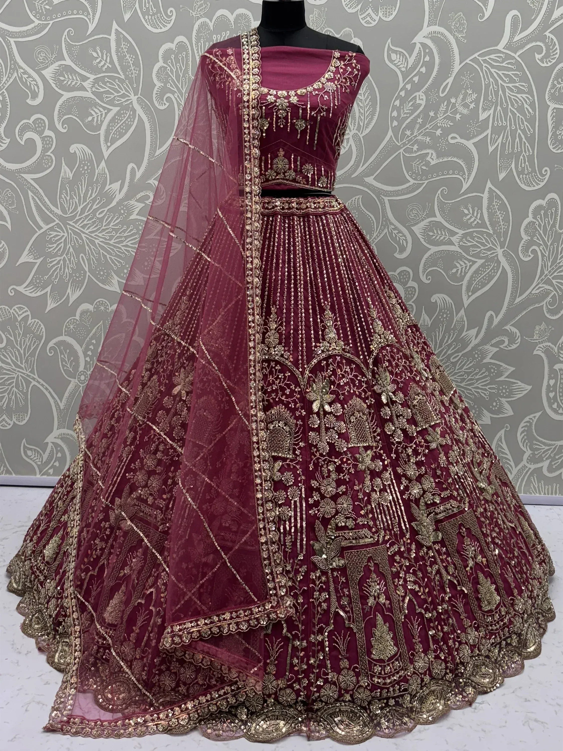 Burgundy designer lehenga choli with gold embroidery and sheer dupatta, ethnic Indian wear