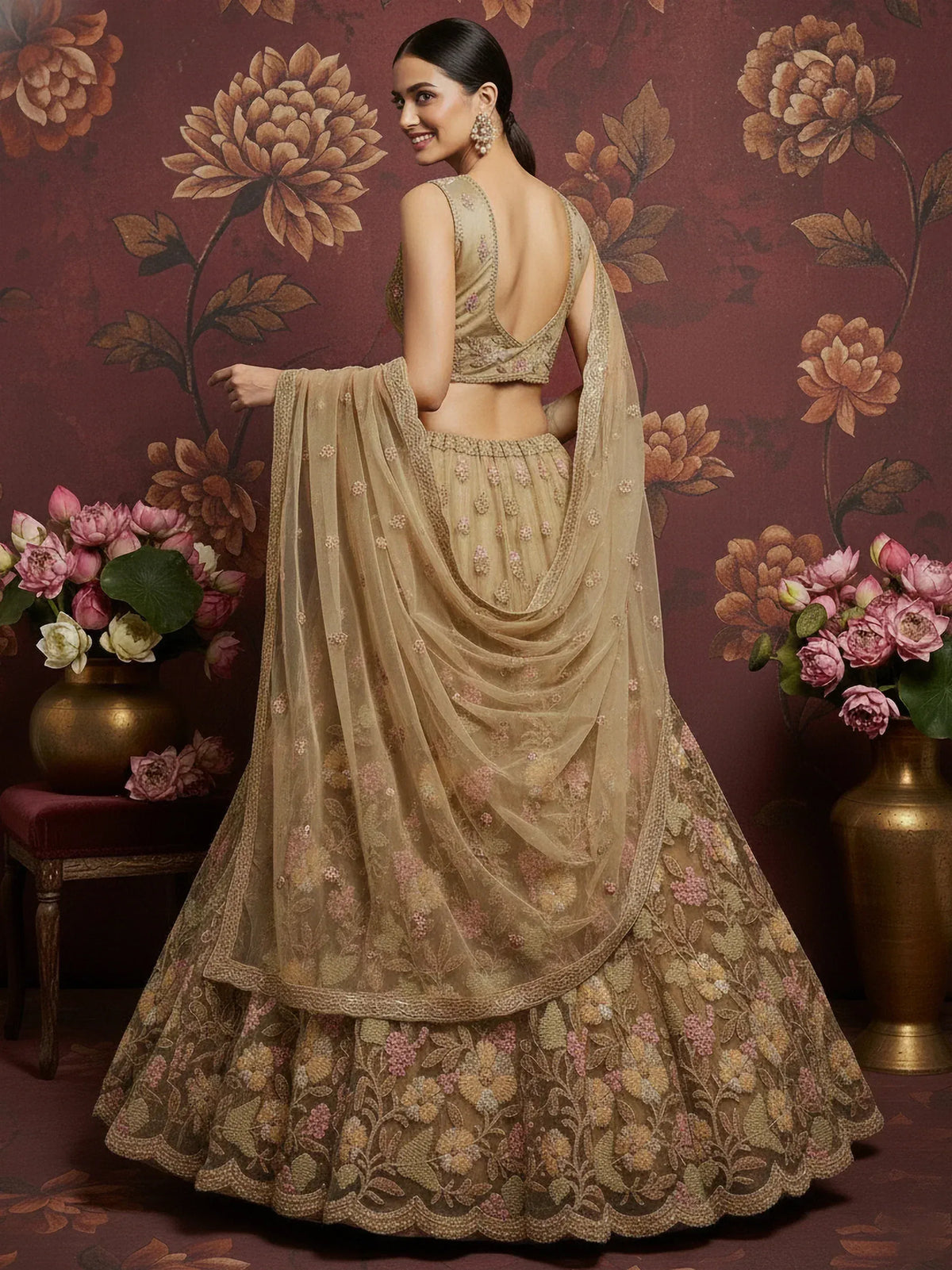 Beige floral embroidered lehenga choli with backless blouse and sheer dupatta, perfect for Indian weddings