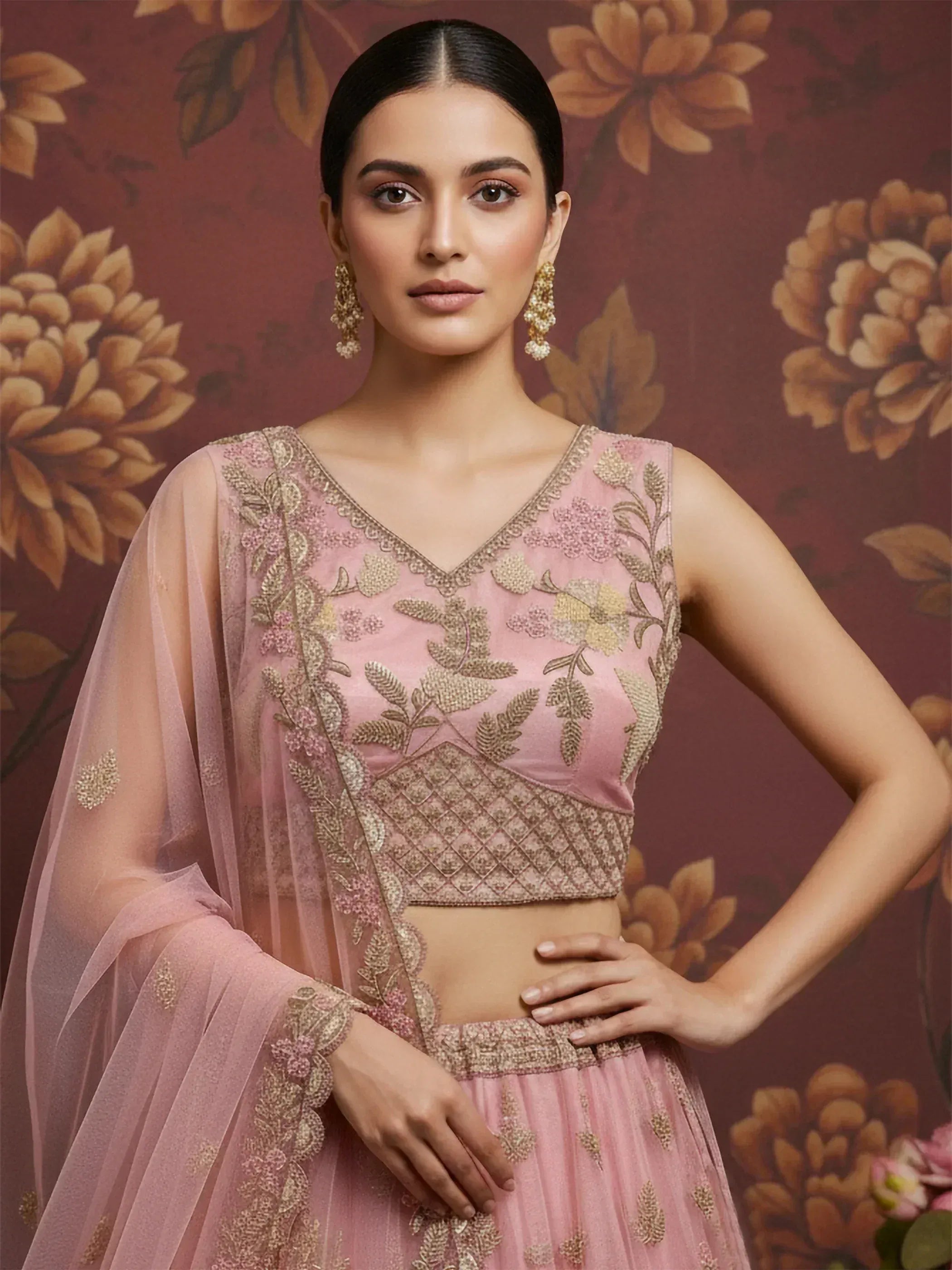 Pink embroidered lehenga choli with gold floral detailing, perfect for Indian ethnic wear occasions