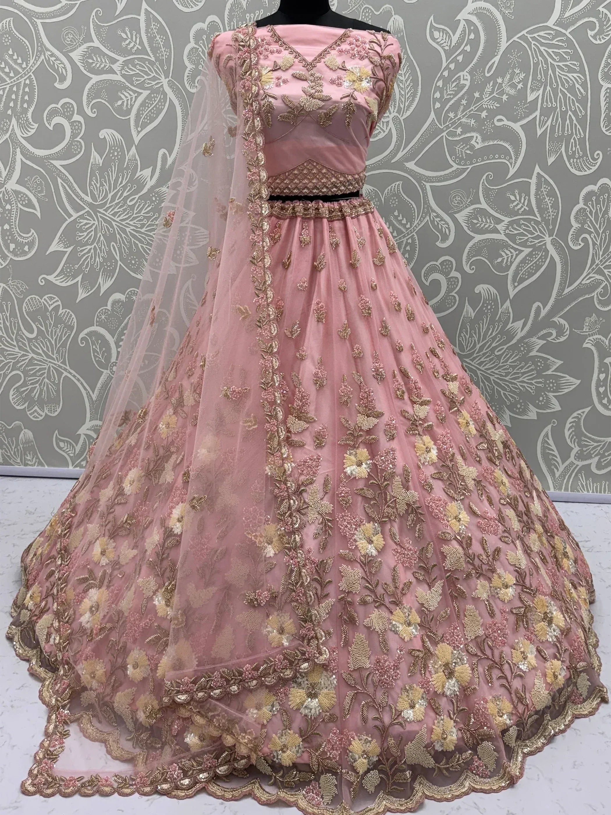 Pink floral embroidered lehenga choli with golden detailing and sheer dupatta