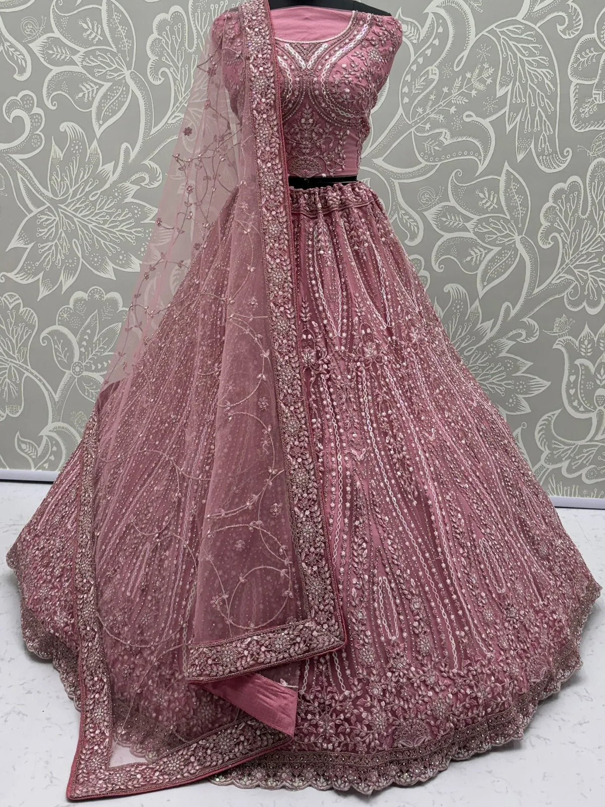 Elegant pink designer lehenga choli with intricate embroidery and embellishments