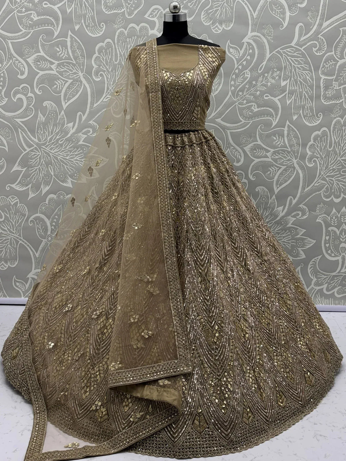 Elegant gold embroidered lehenga choli with dupatta, perfect for Indian weddings and festive occasions.