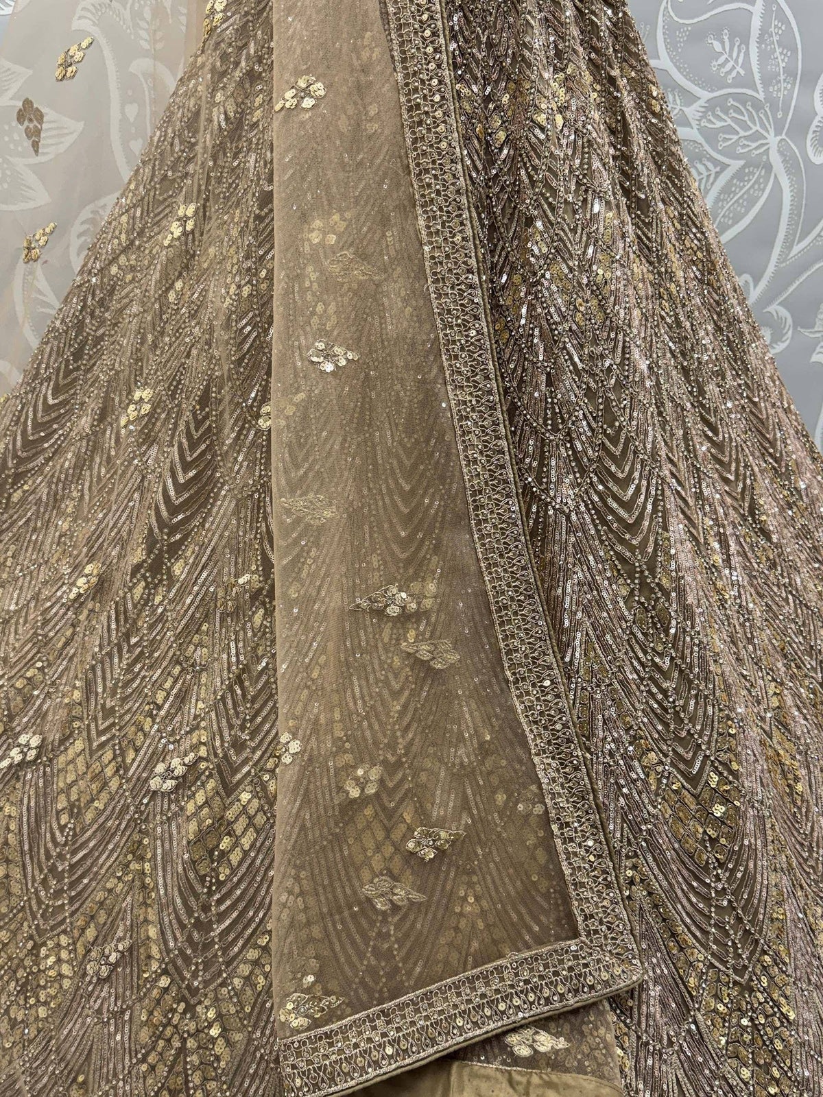 Elegant brown ethnic gown with intricate gold sequin embroidery and detailed border work