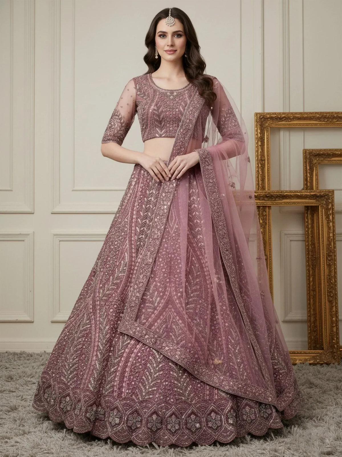 Dusty pink embroidered lehenga choli with sheer dupatta, perfect for Indian weddings and festive occasions.