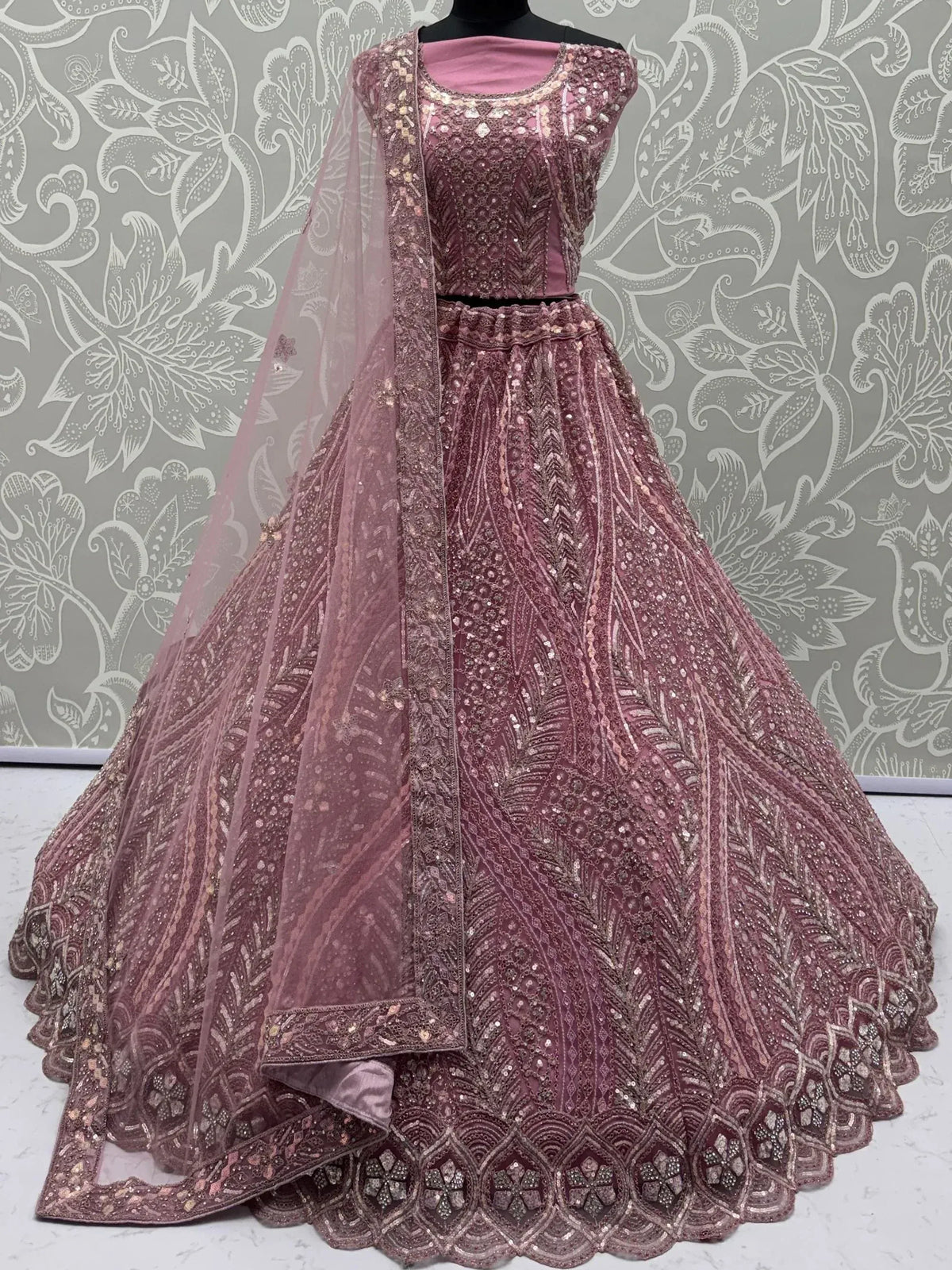 Dusty rose designer lehenga choli with heavy sequin embroidery and sheer dupatta, perfect for weddings