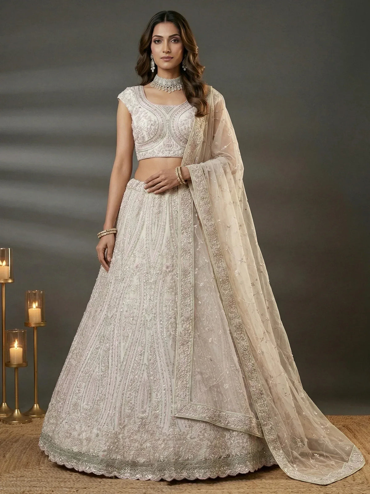 Elegant white embroidered lehenga choli with sheer dupatta, perfect for Indian weddings and festive occasions.