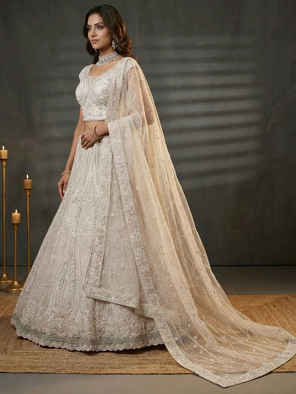 Elegant ivory lehenga choli with intricate embroidery and sheer dupatta, perfect for weddings and festive occasions.