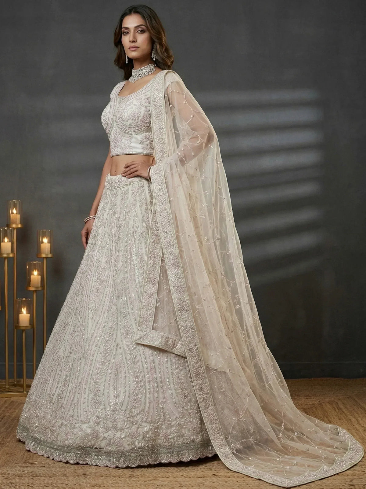 Elegant white embroidered lehenga choli with sheer dupatta, perfect for Indian weddings and festive occasions.