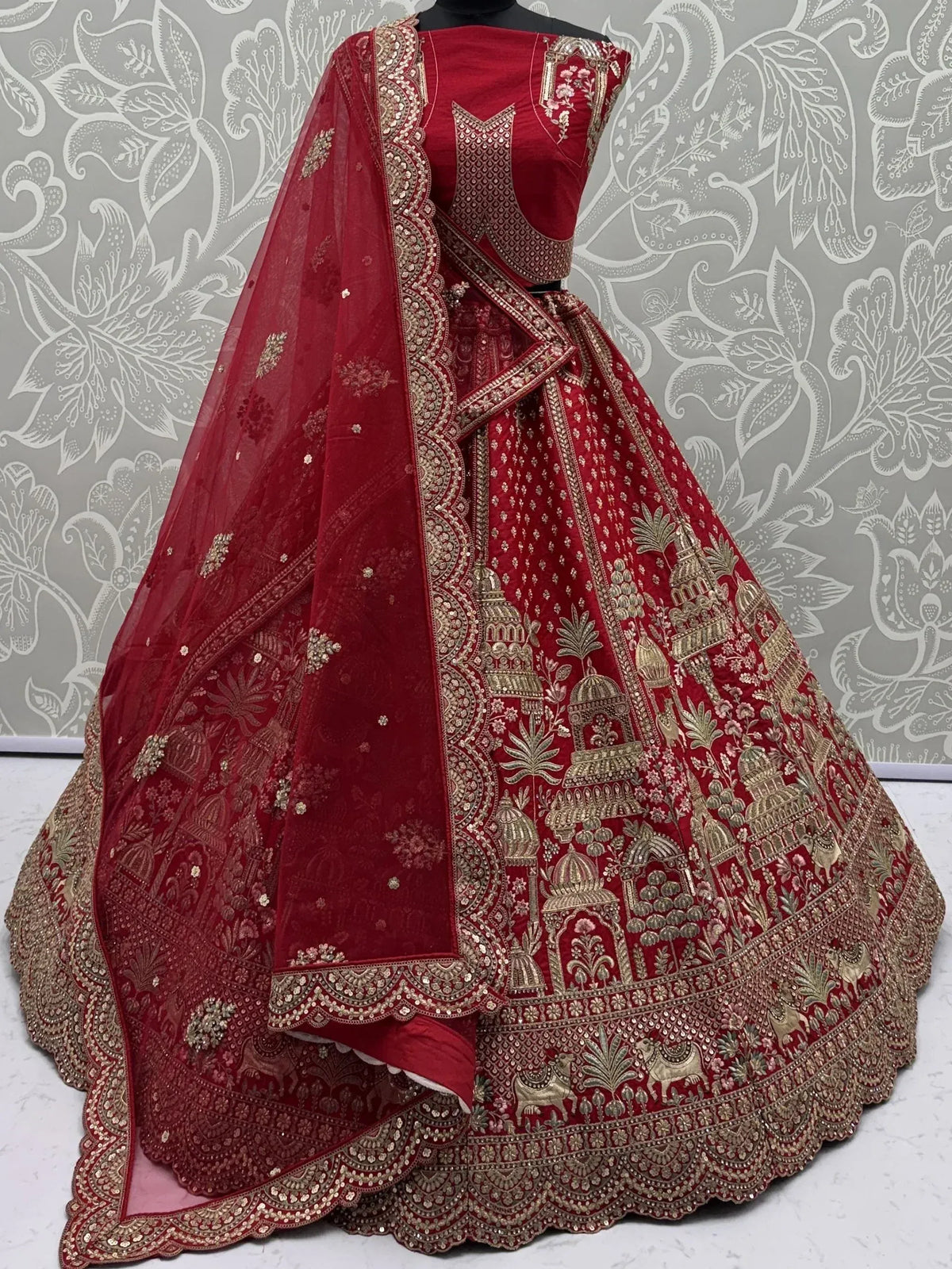 Red embroidered lehenga choli with gold temple motifs and sheer dupatta for Indian ethnic wear