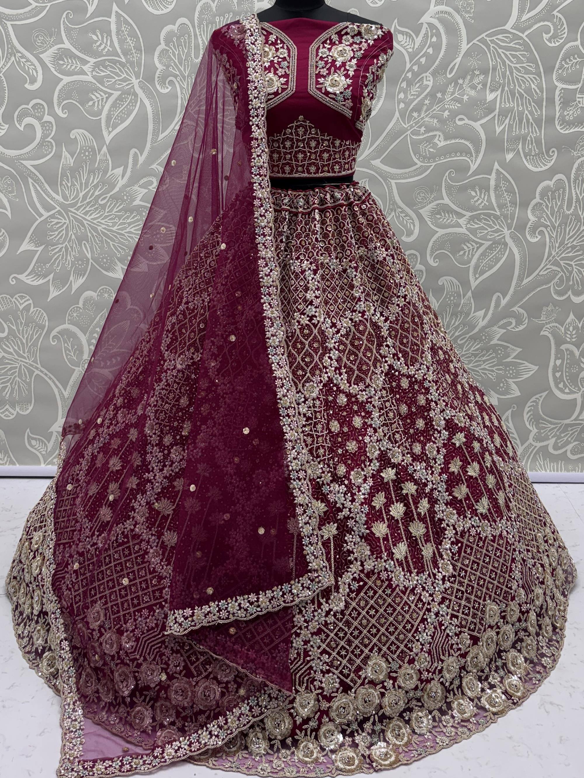 Maroon designer lehenga choli with intricate gold embroidery and floral patterns