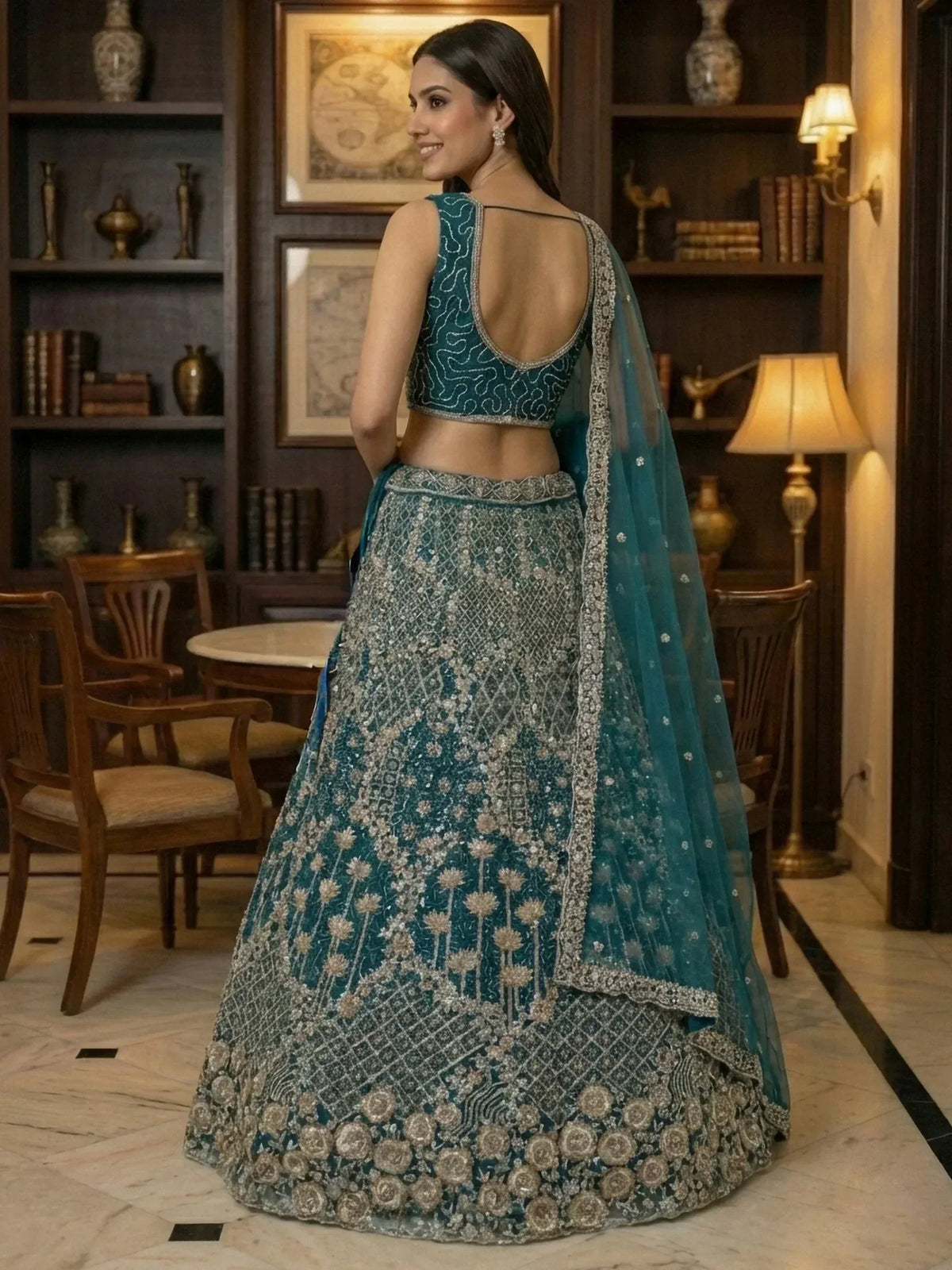Teal designer lehenga choli with intricate silver embroidery and floral motifs, perfect for Indian ethnic wear.