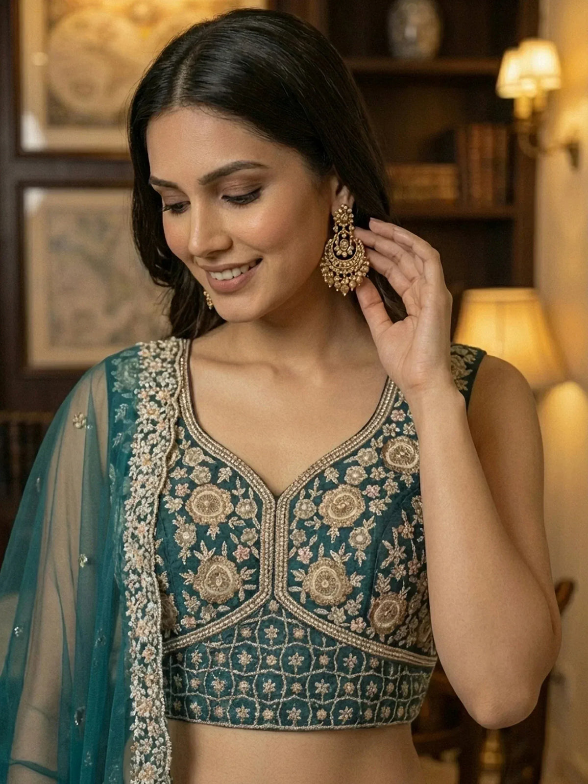 Elegant teal embroidered blouse with floral designs and matching dupatta, styled with gold jhumka earrings.