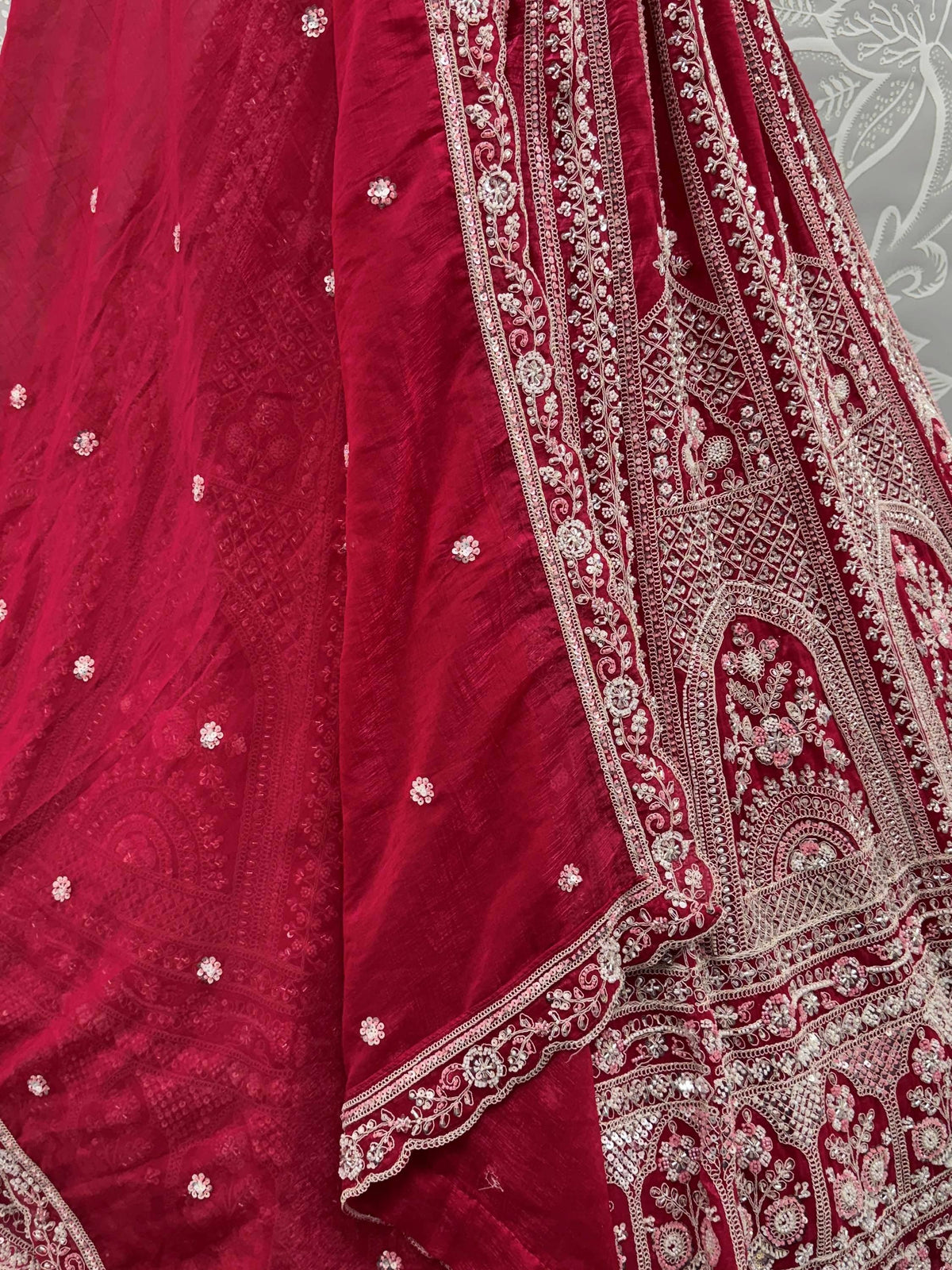 Red embroidered lehenga choli with intricate floral detailing and sequin work